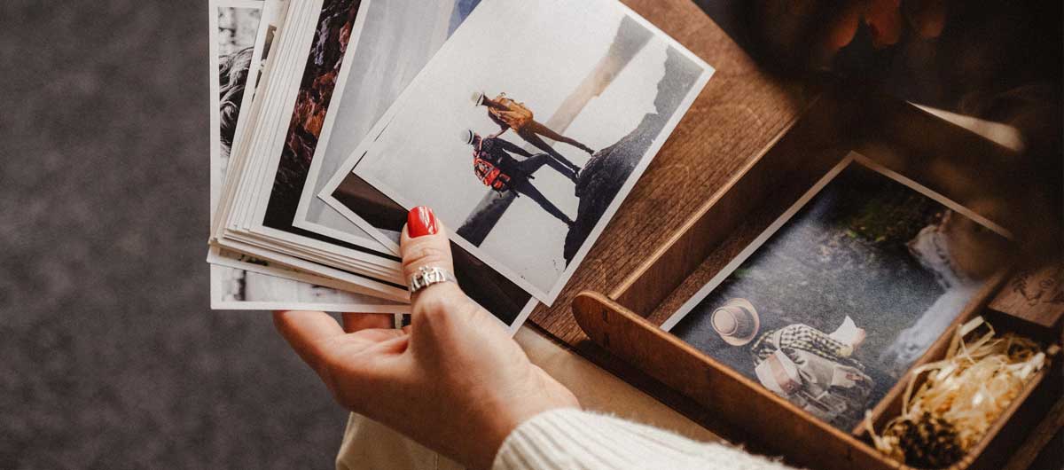 Woman holding wedding photos above personalized wooden wedding photo box by NZHANDICRAFT