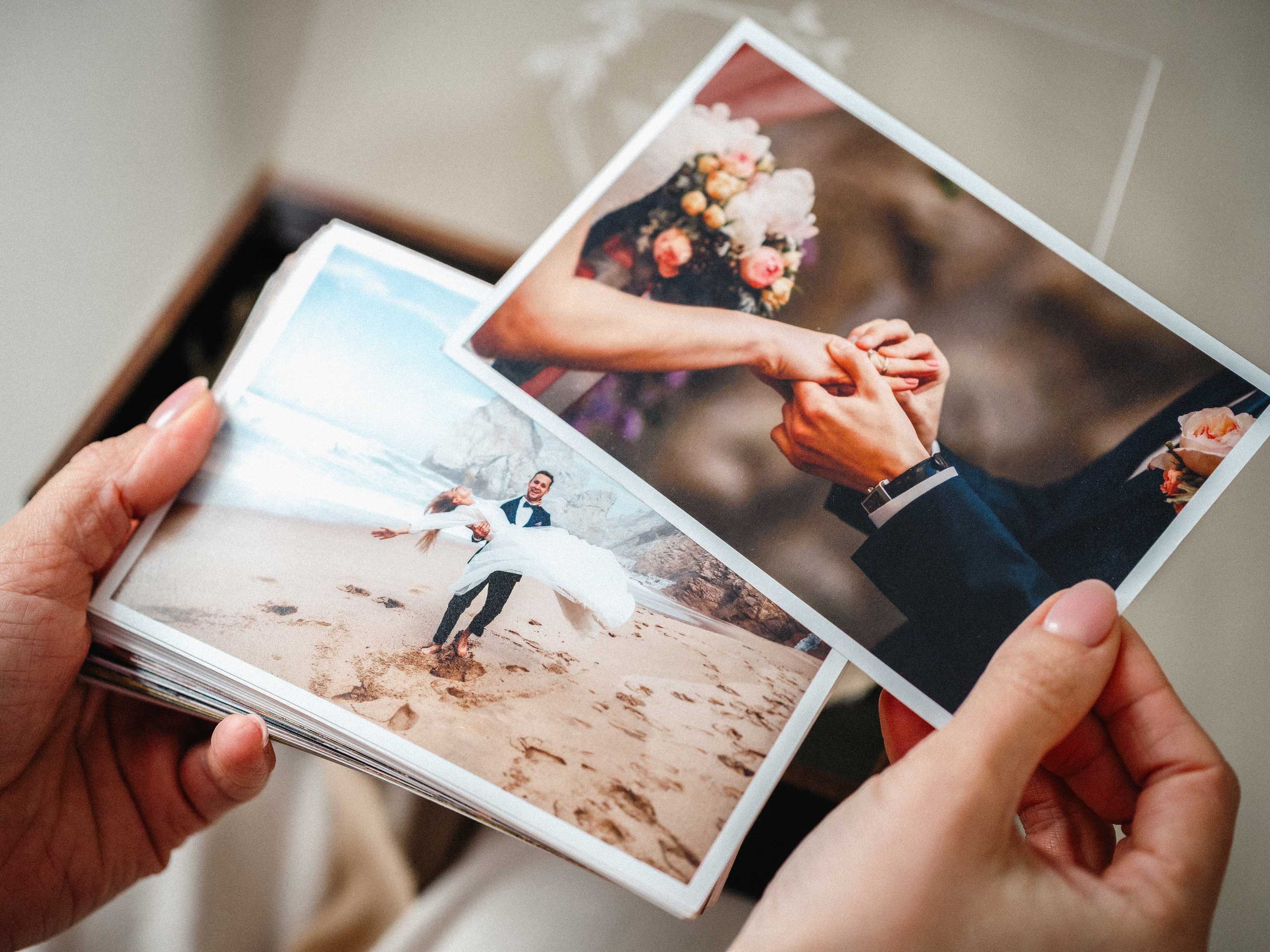 Wedding photo prints removed from black wooden photo box with USB