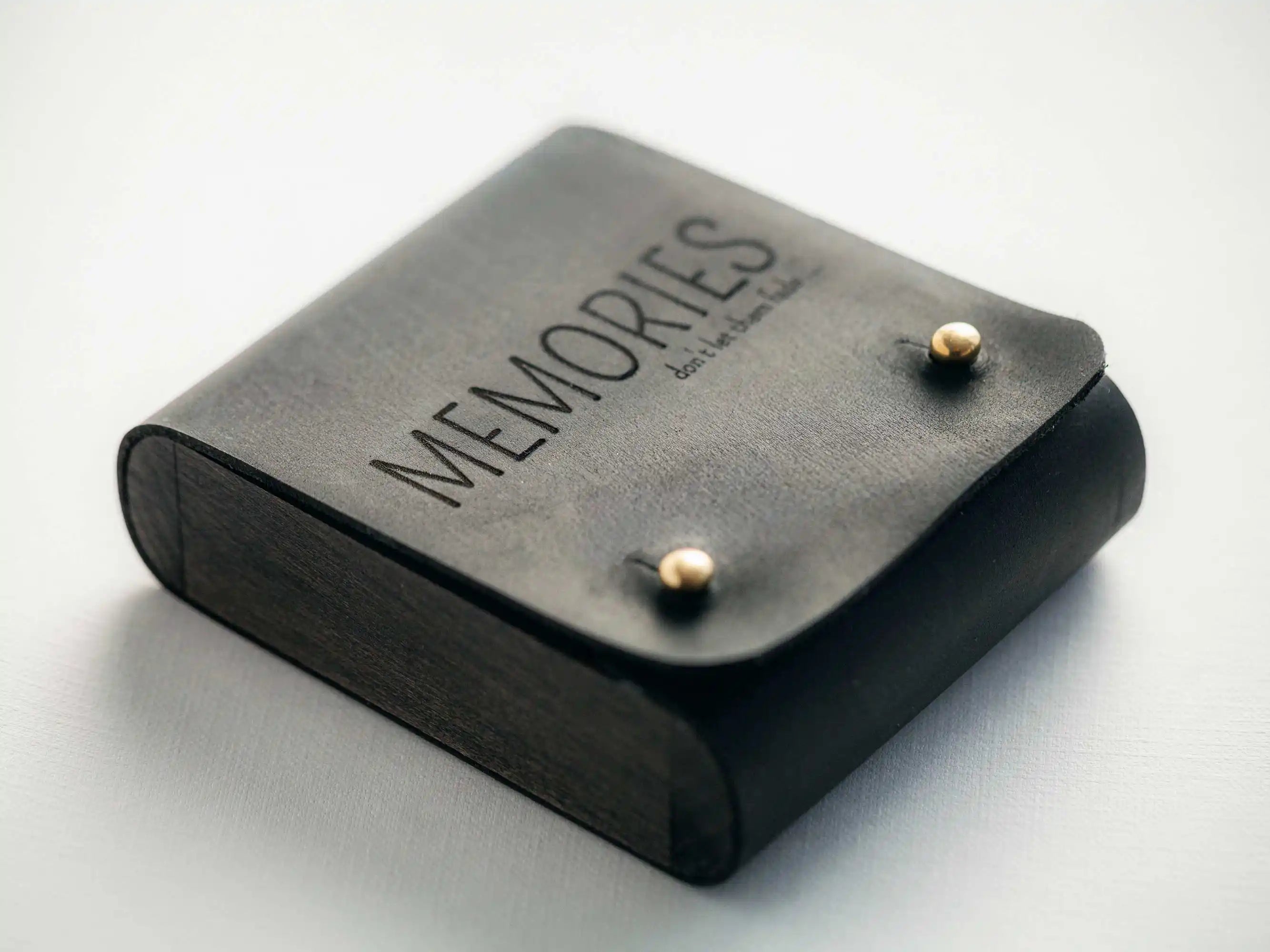 Black leather USB box with “MEMORIES” engraving, clean studio shot on white background