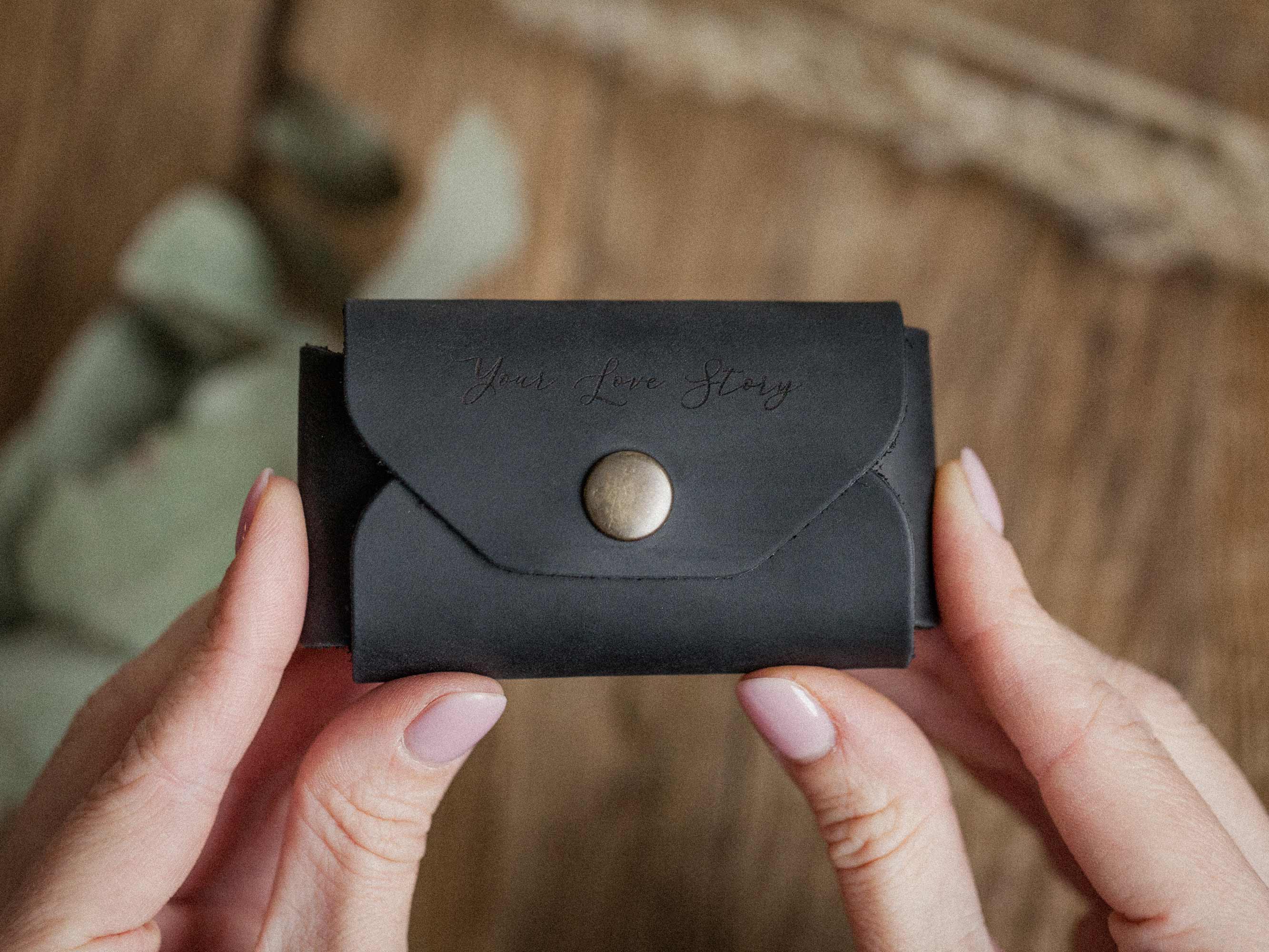 black leather usb envelope front view held in hands