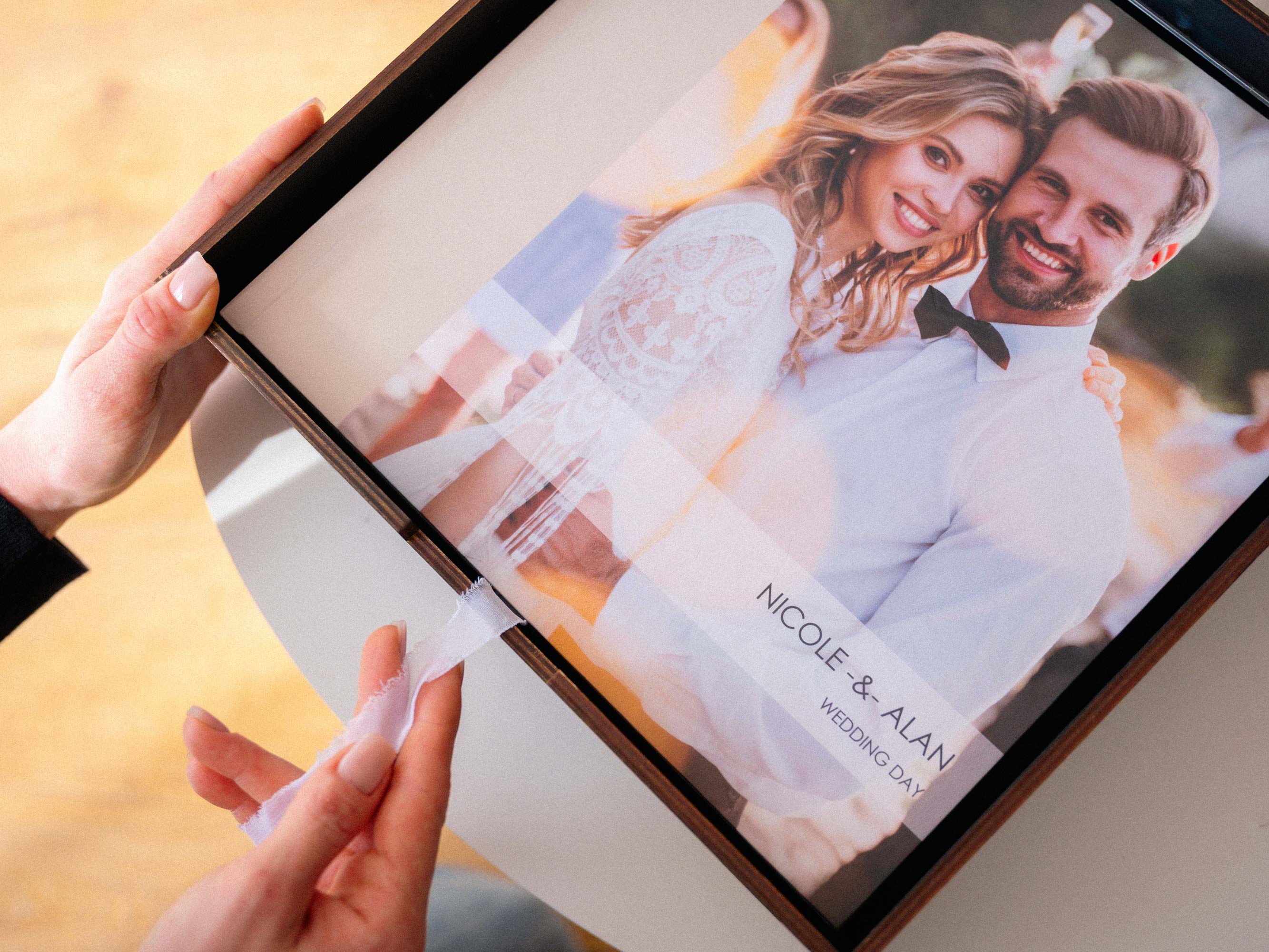 Black photo album storage box with 12x12 wedding album inside