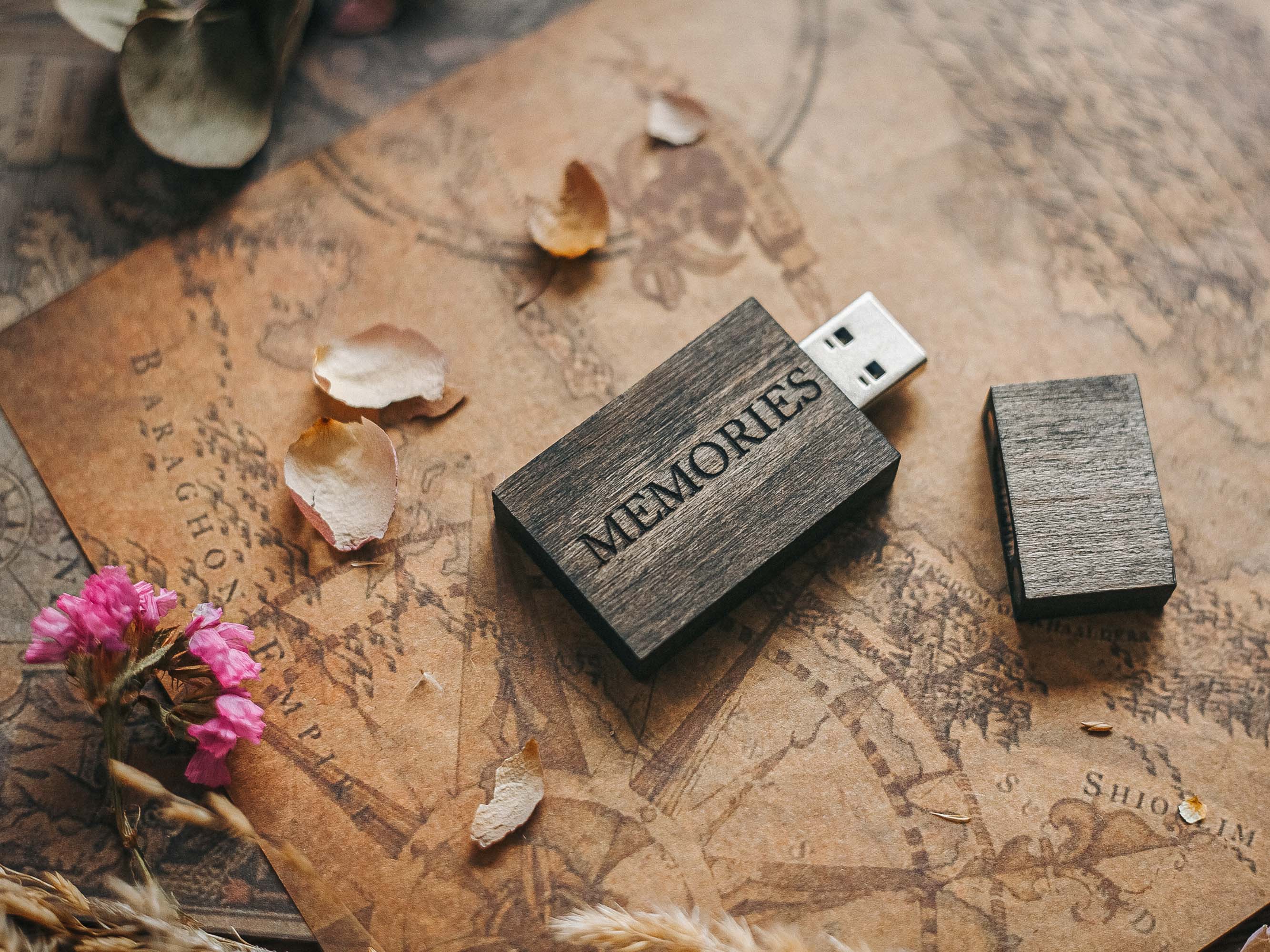 Engraved black wooden USB flash drive with magnetic cap on neutral fabric