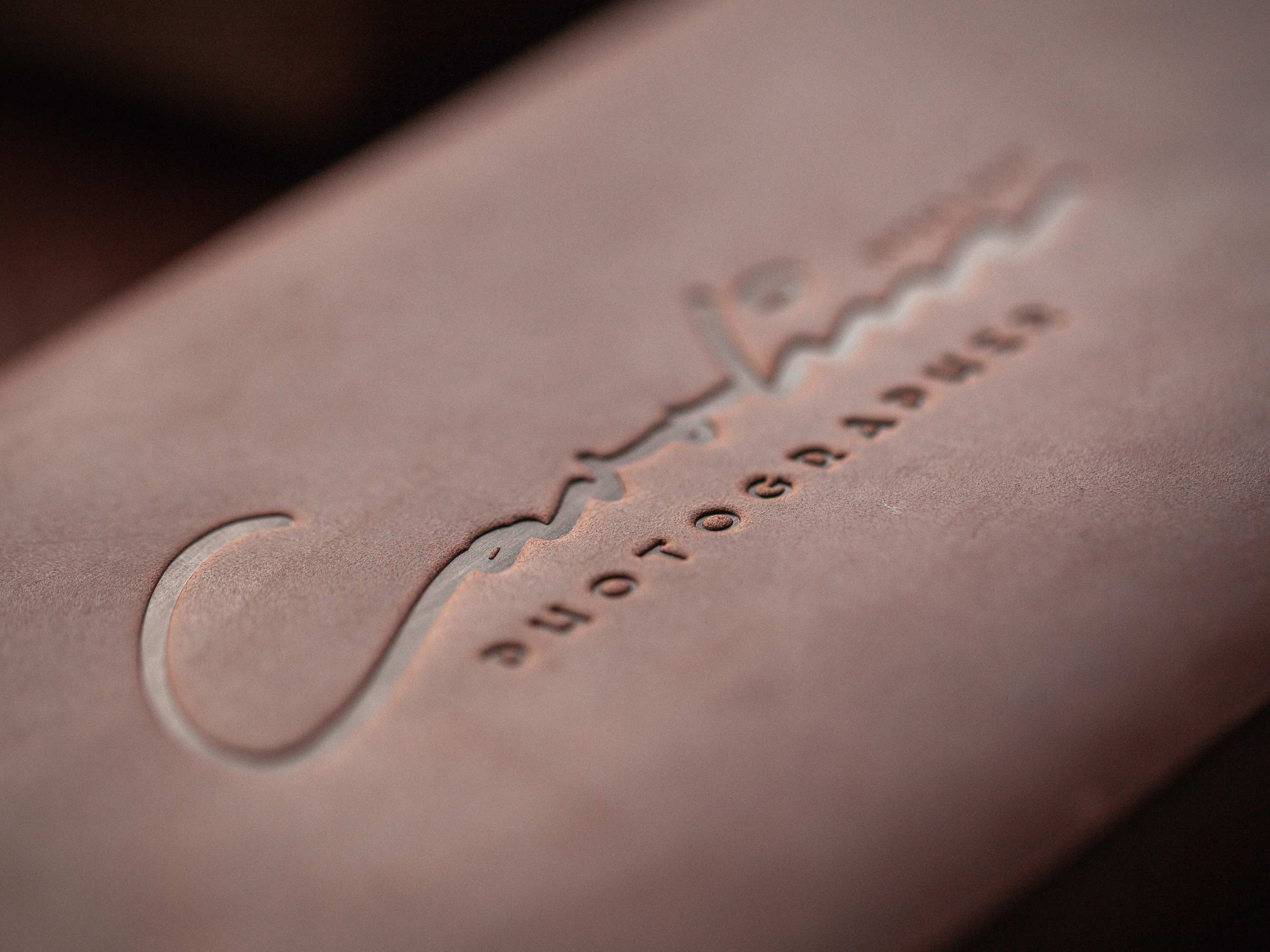 Dream Factory hot stamping machine with several leather envelopes ready for logo stamping.