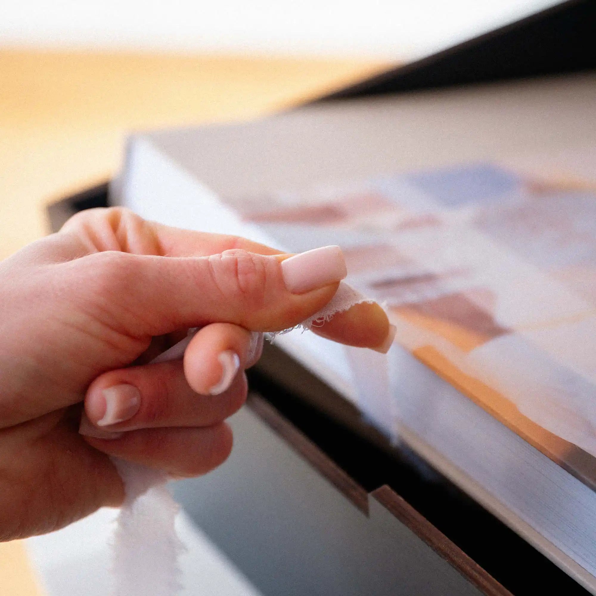 Empty Gold Oak wedding album box with engraved acrylic lid open on a white table
