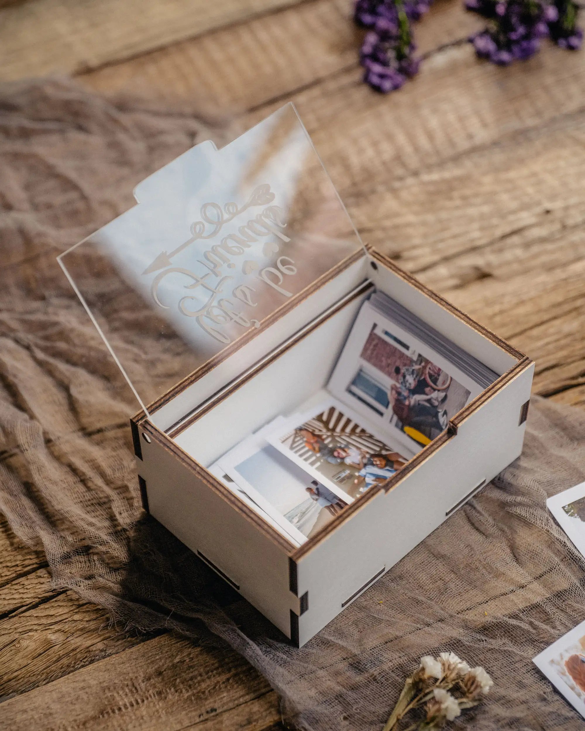 White wooden Instax Mini photo storage box opened on rustic fabric