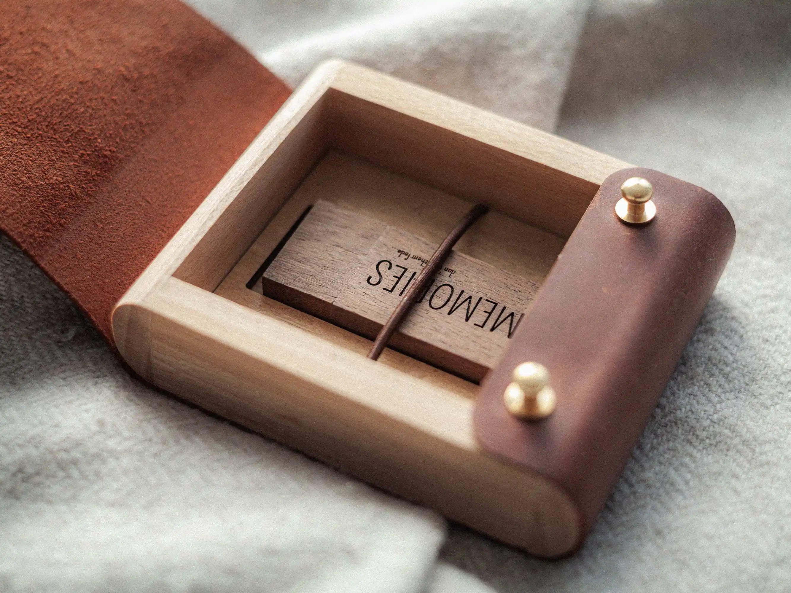 Open cognac leather USB box with wooden USB drive inside, premium client delivery