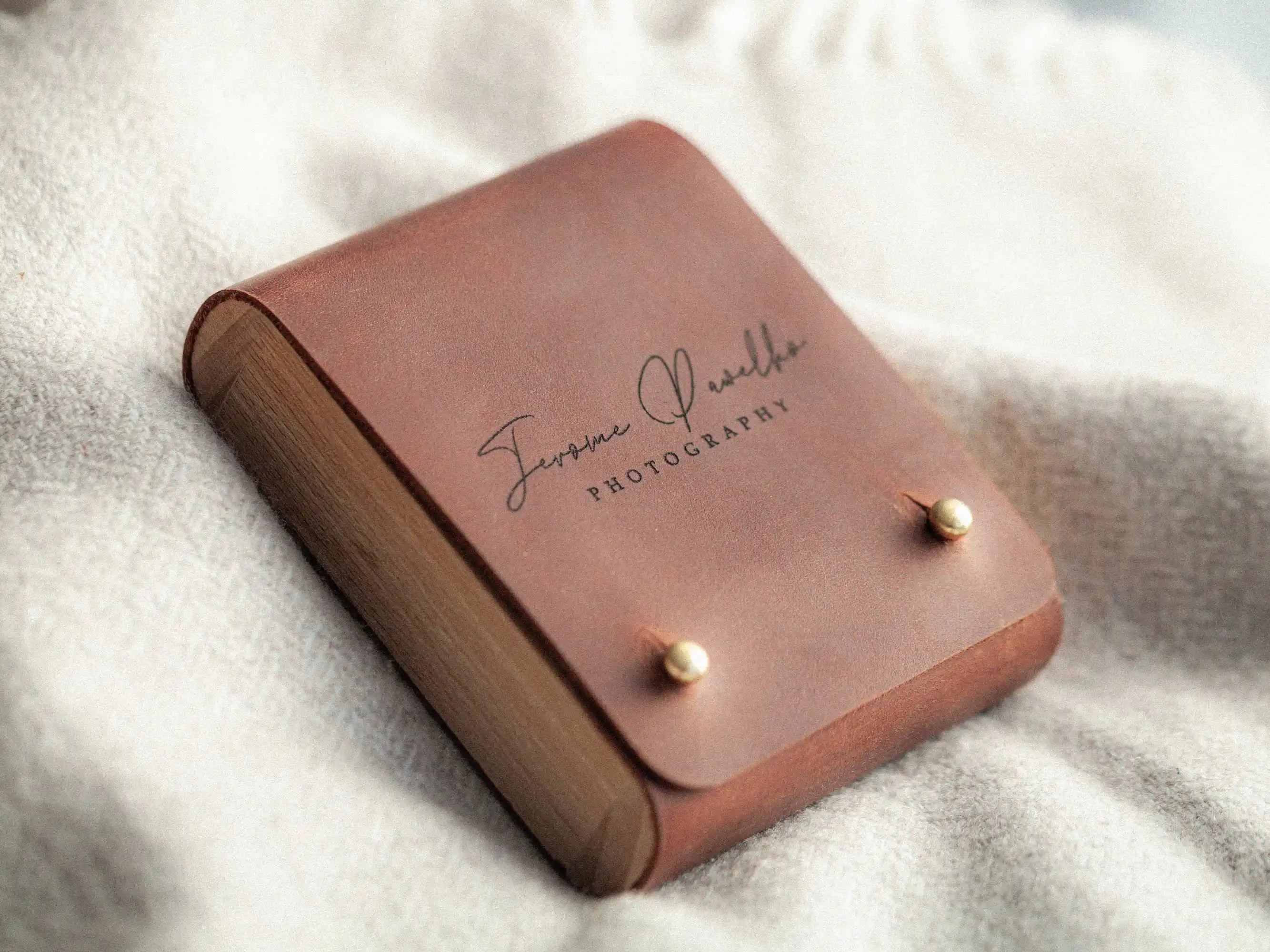Closed leather USB box on blanket, minimalist wedding photographer packaging