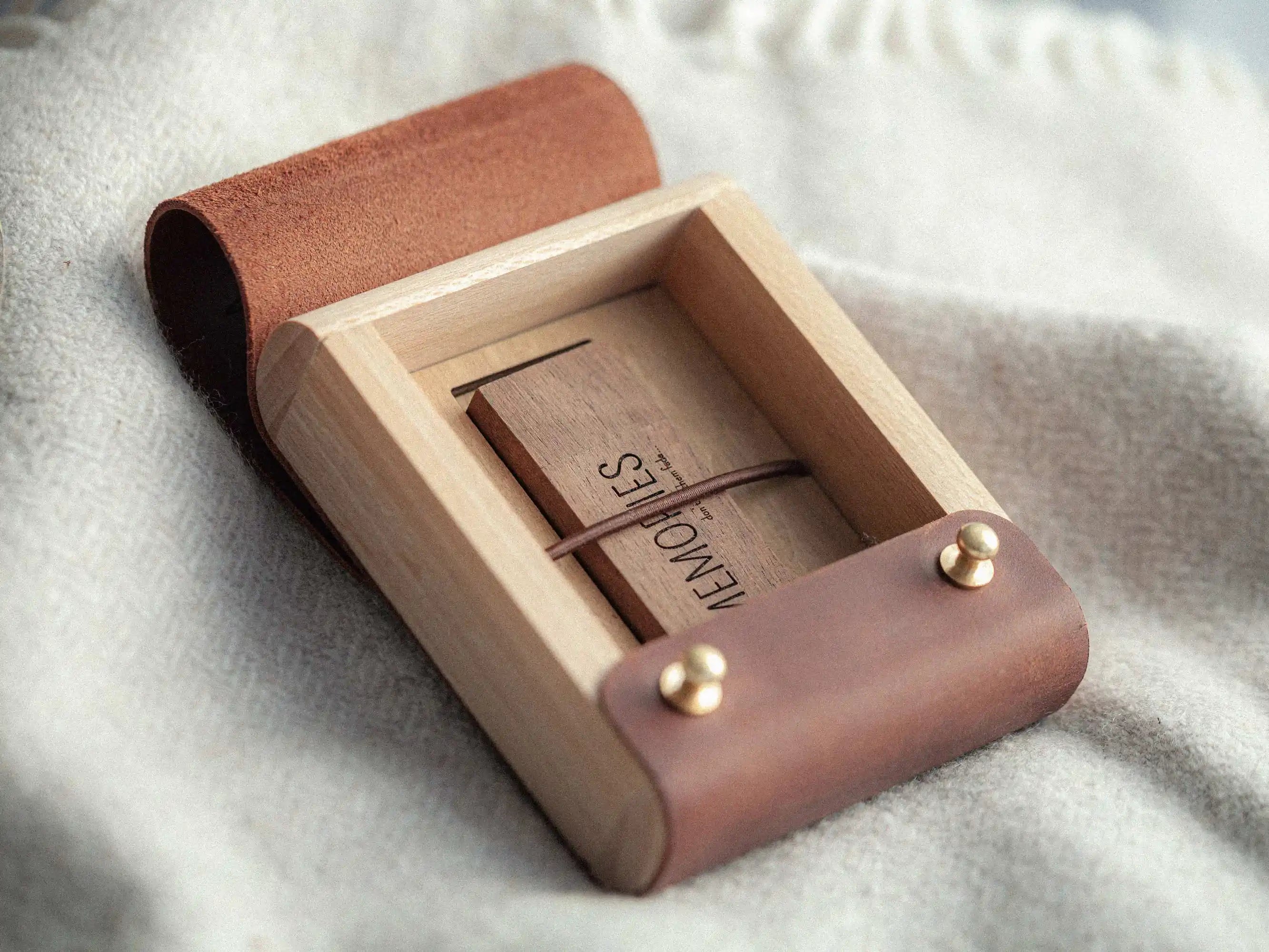 Open USB box with wooden USB drive, elastic strap holder detail, lifestyle shot