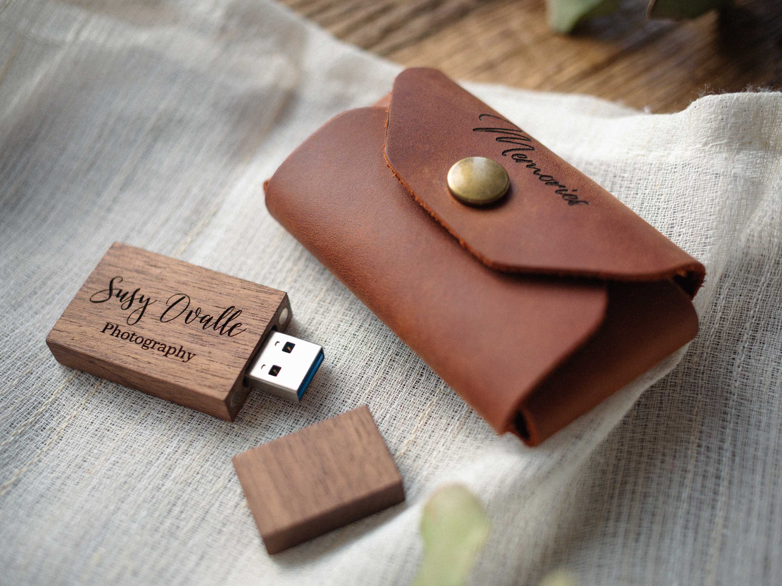 Cognac leather USB case with Memories engraving and wooden USB 3.0 flash drive on linen fabric