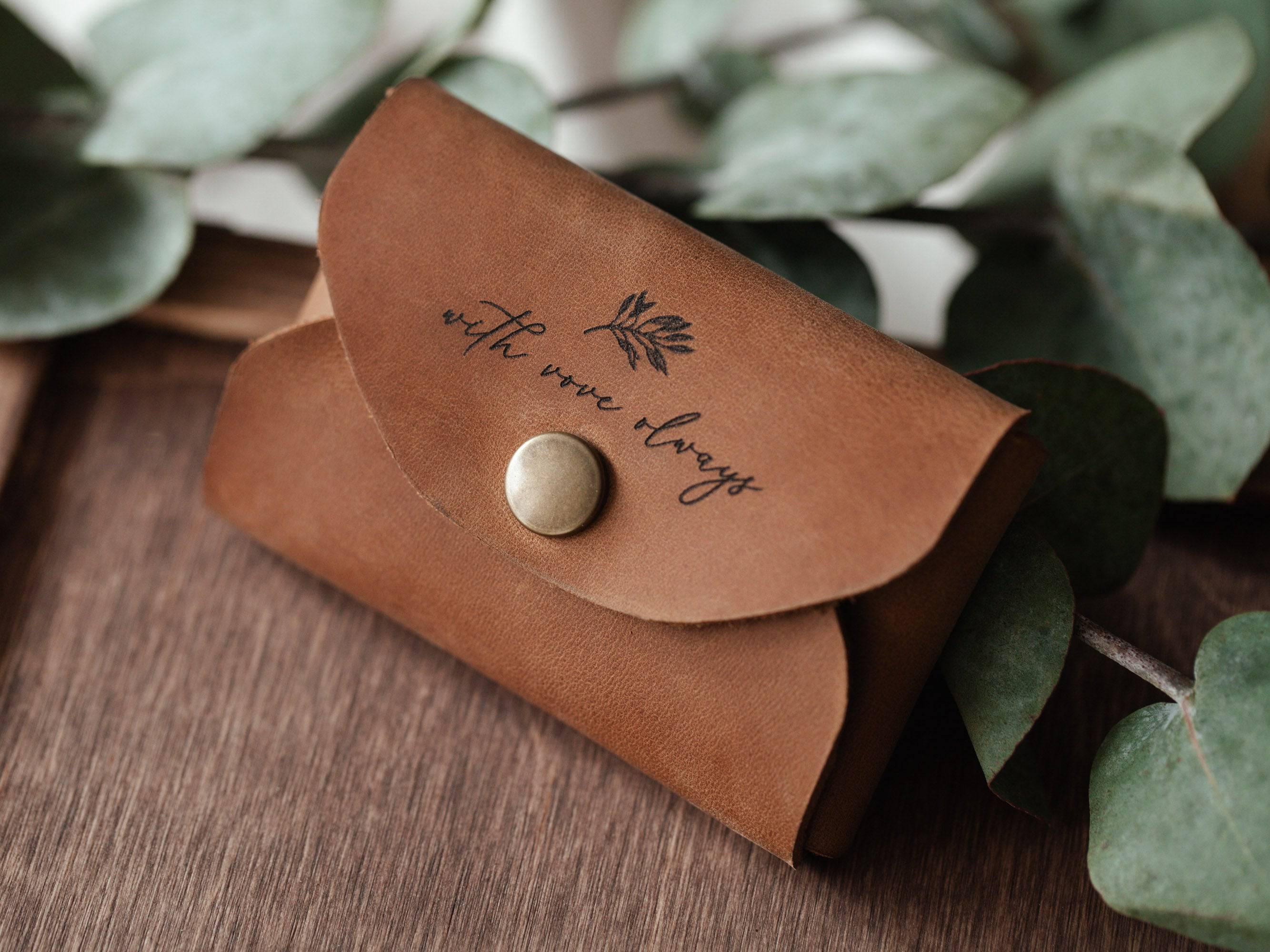 Personalized cognac leather USB envelope with botanical laser engraving and eucalyptus leaves
