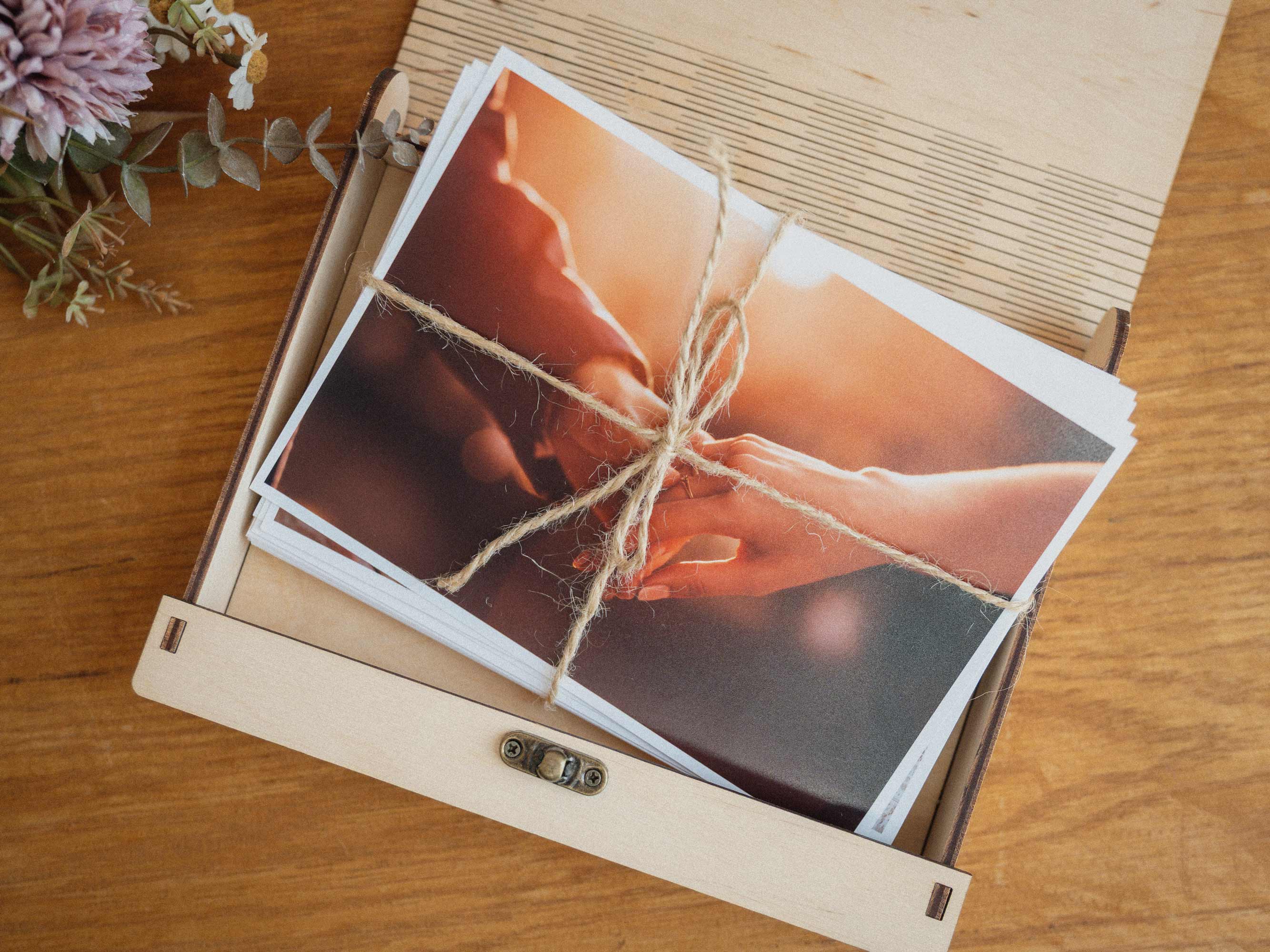 Open Maple wooden photo box with wedding photos