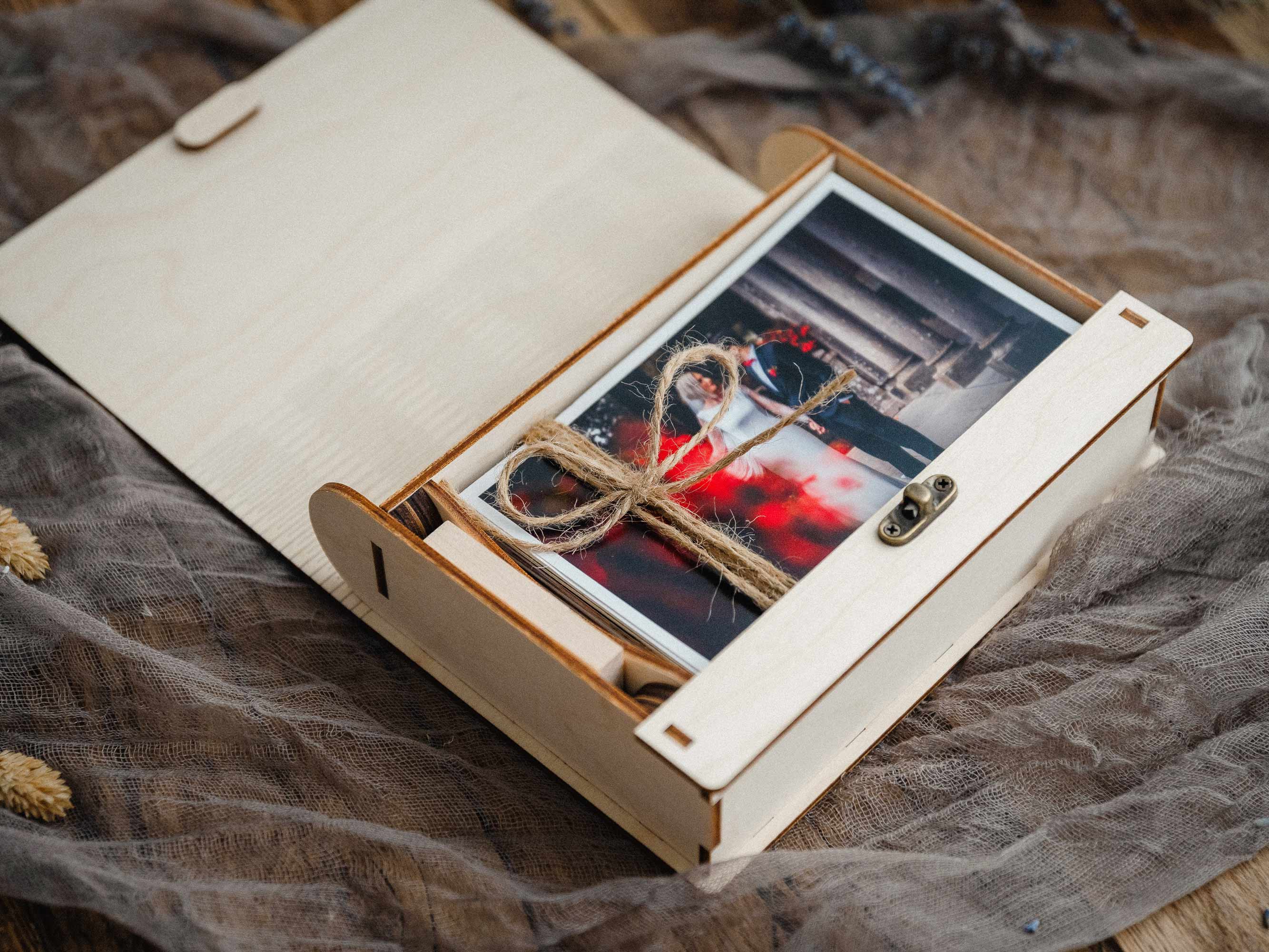 Open maple wooden photo box showing photo prints inside and a USB compartment