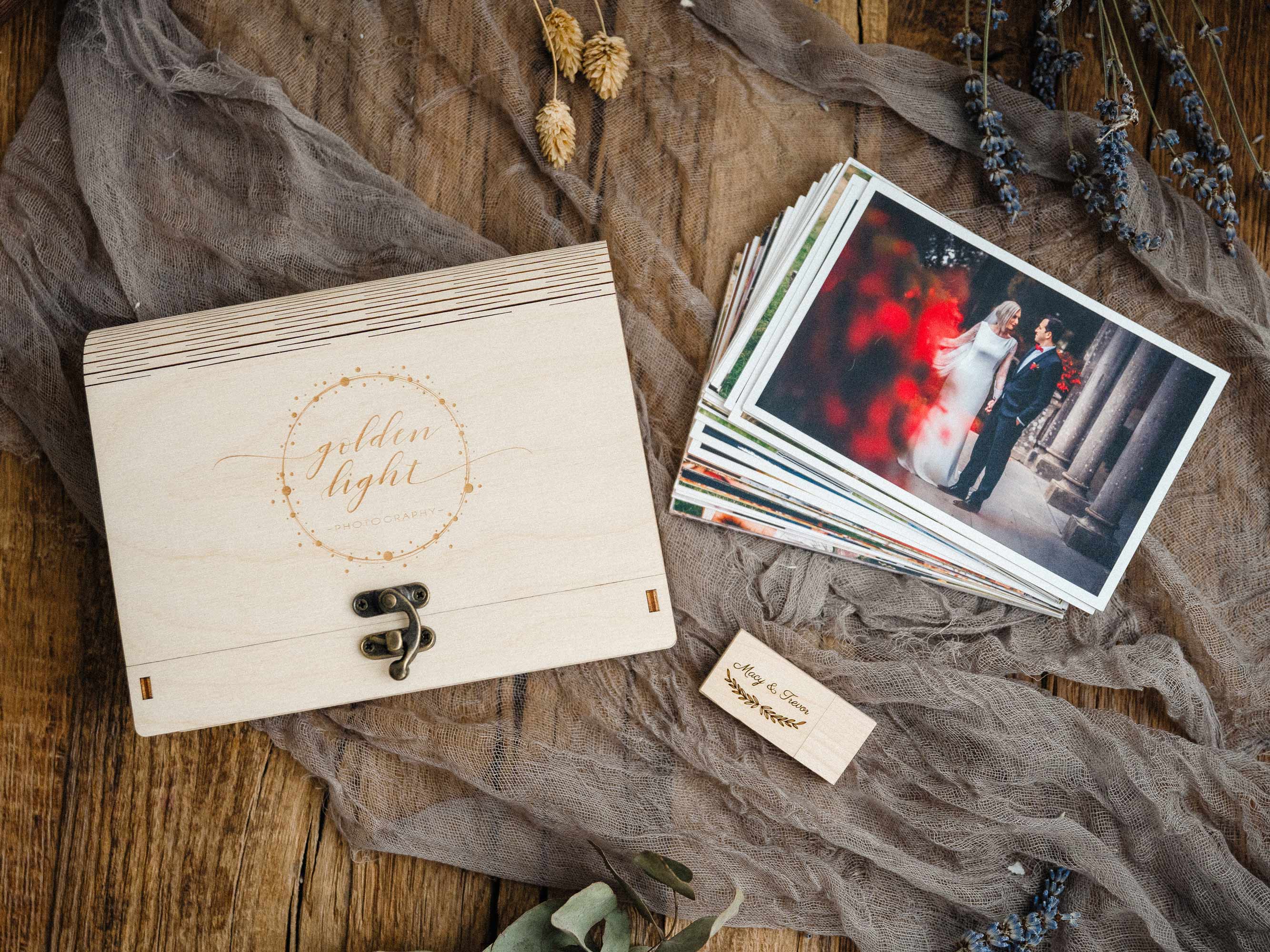 Maple engraved wedding photo box flat lay with printed photos and wooden USB