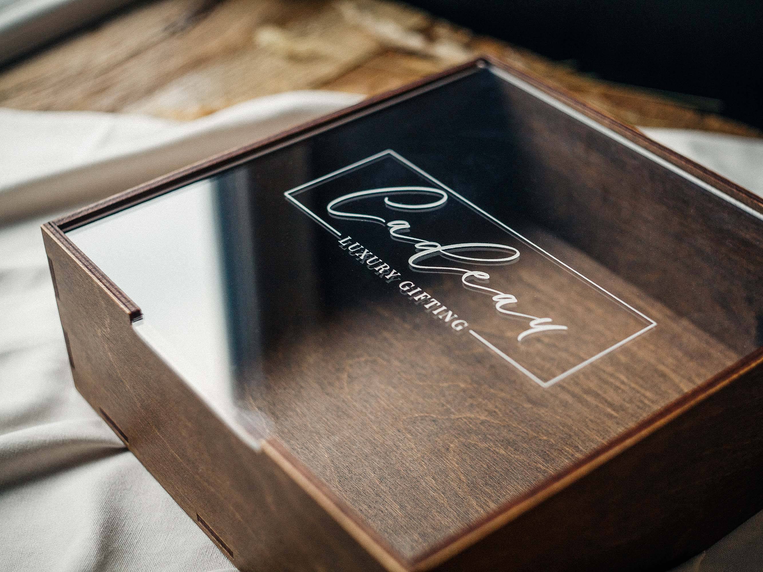 Walnut keepsake gift box with clear acrylic lid and engraved logo