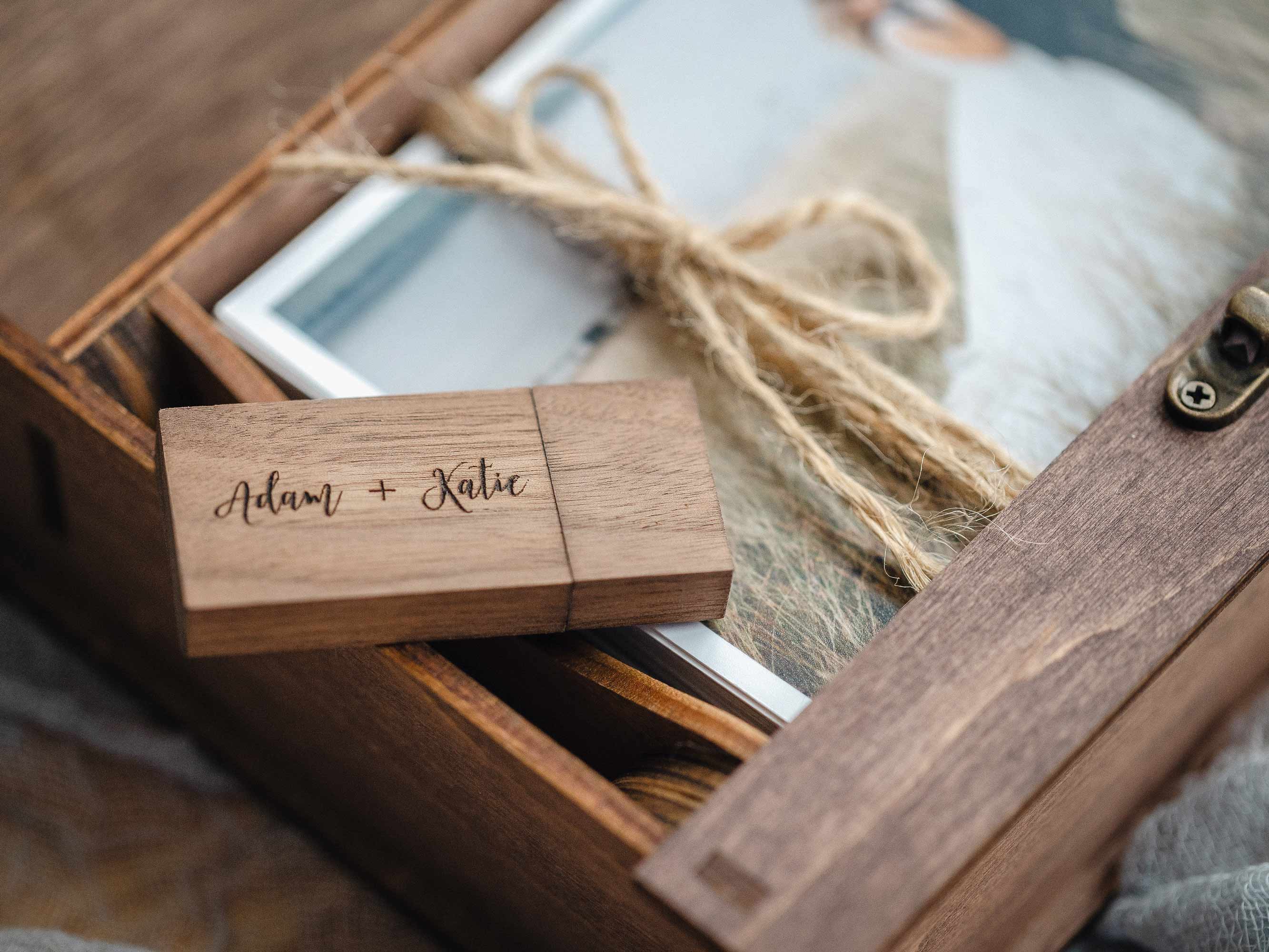 Wooden USB drive in compartment inside walnut photo box with twine bundle