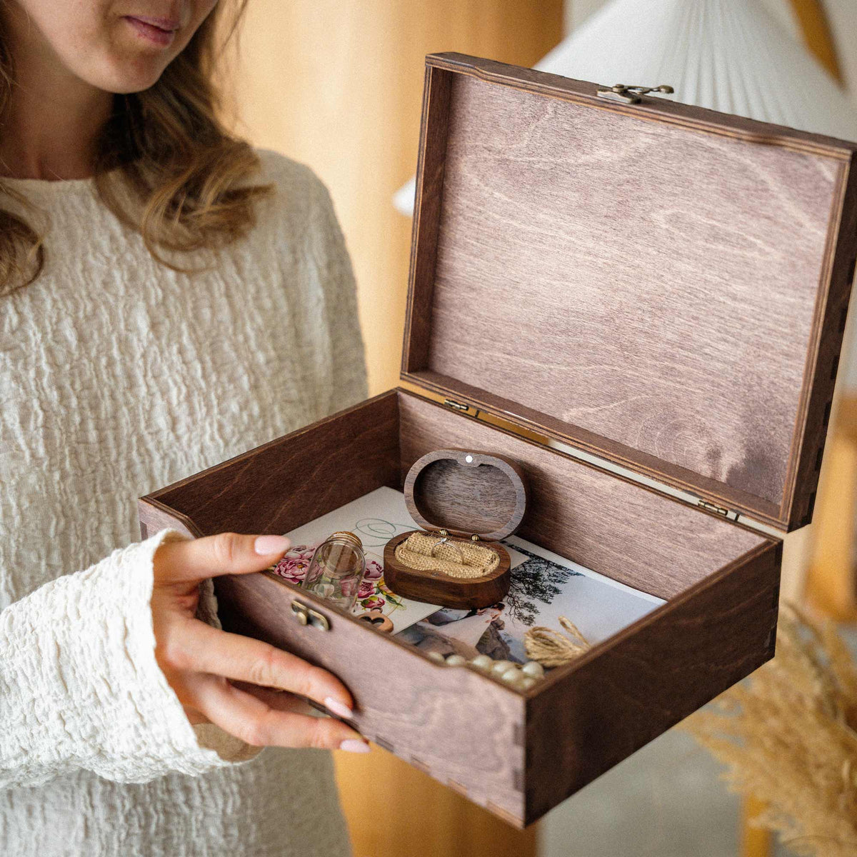 Open walnut wedding memory box filled with meaningful keepsakes
