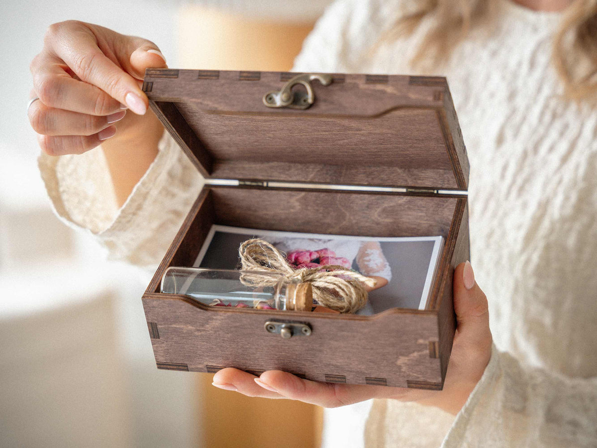 Small personalized keepsake box open with wedding mementos inside