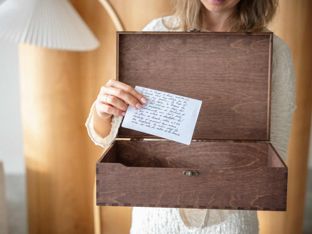 Open wooden keepsake box with handwritten wedding note