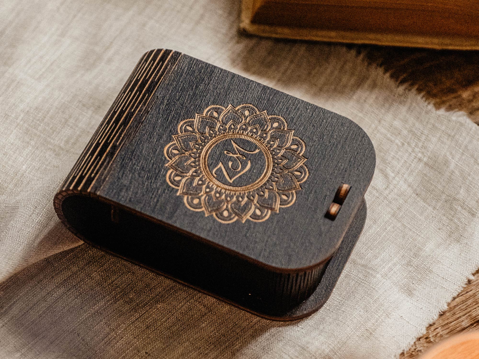 Black engraved USB keepsake box on linen fabric with warm styled decor