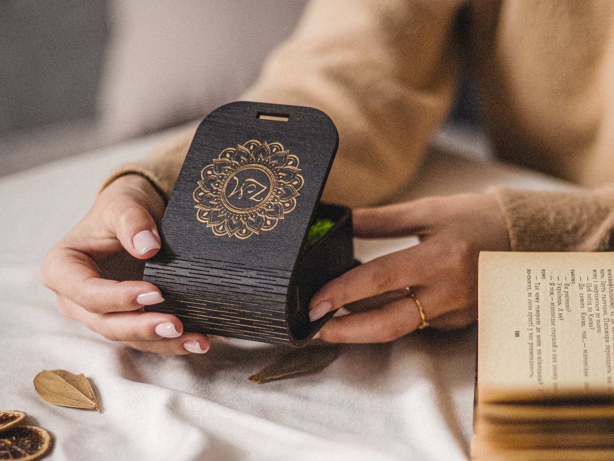 Personalized black USB keepsake box held in hands with gold engraved monogram