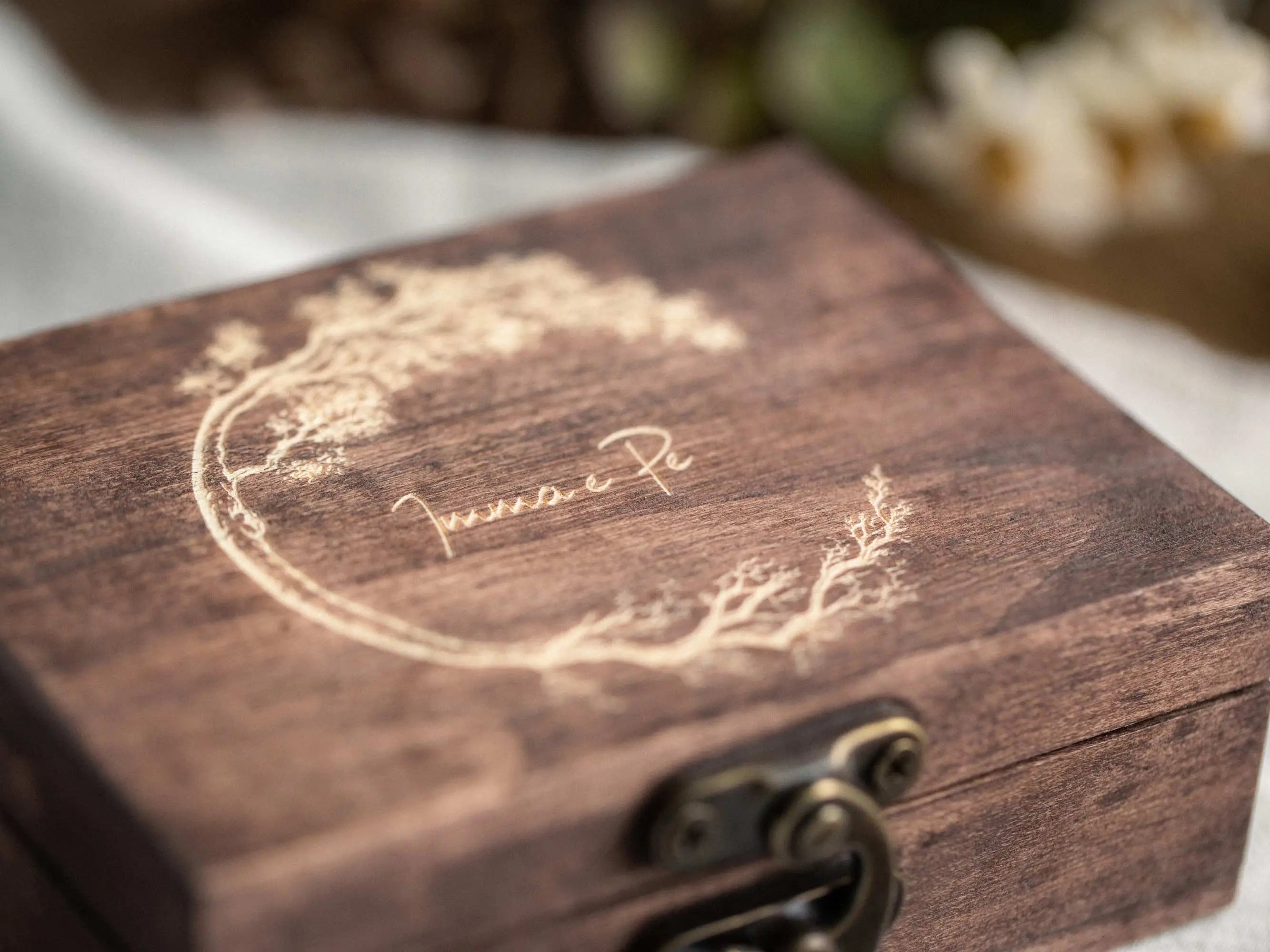 Close-up of custom engraving on the lid of a wooden USB keepsake box.