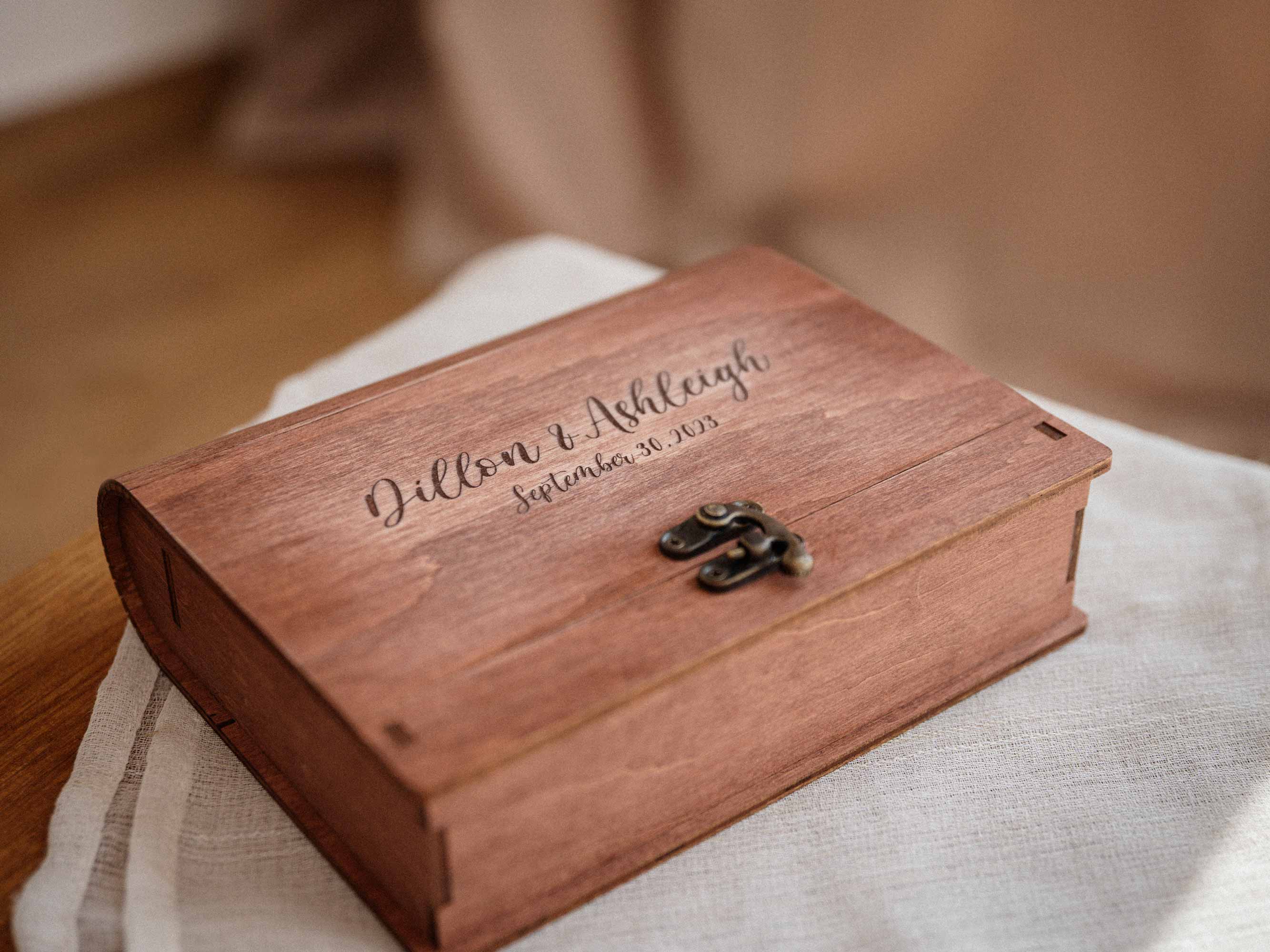 Closed teak wooden photo box with engraved wedding names