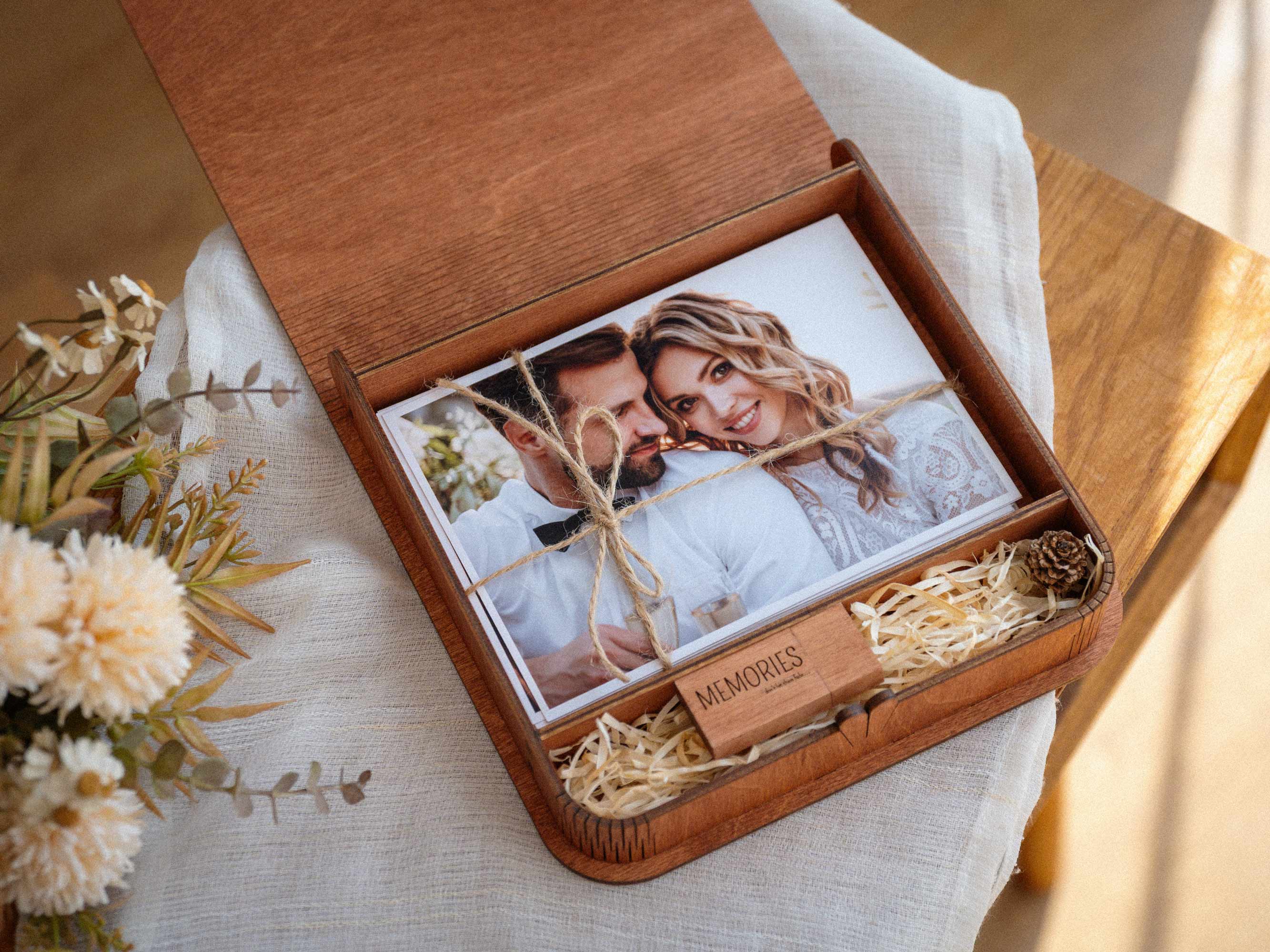 Open teak wedding photo box with USB compartment and printed photos