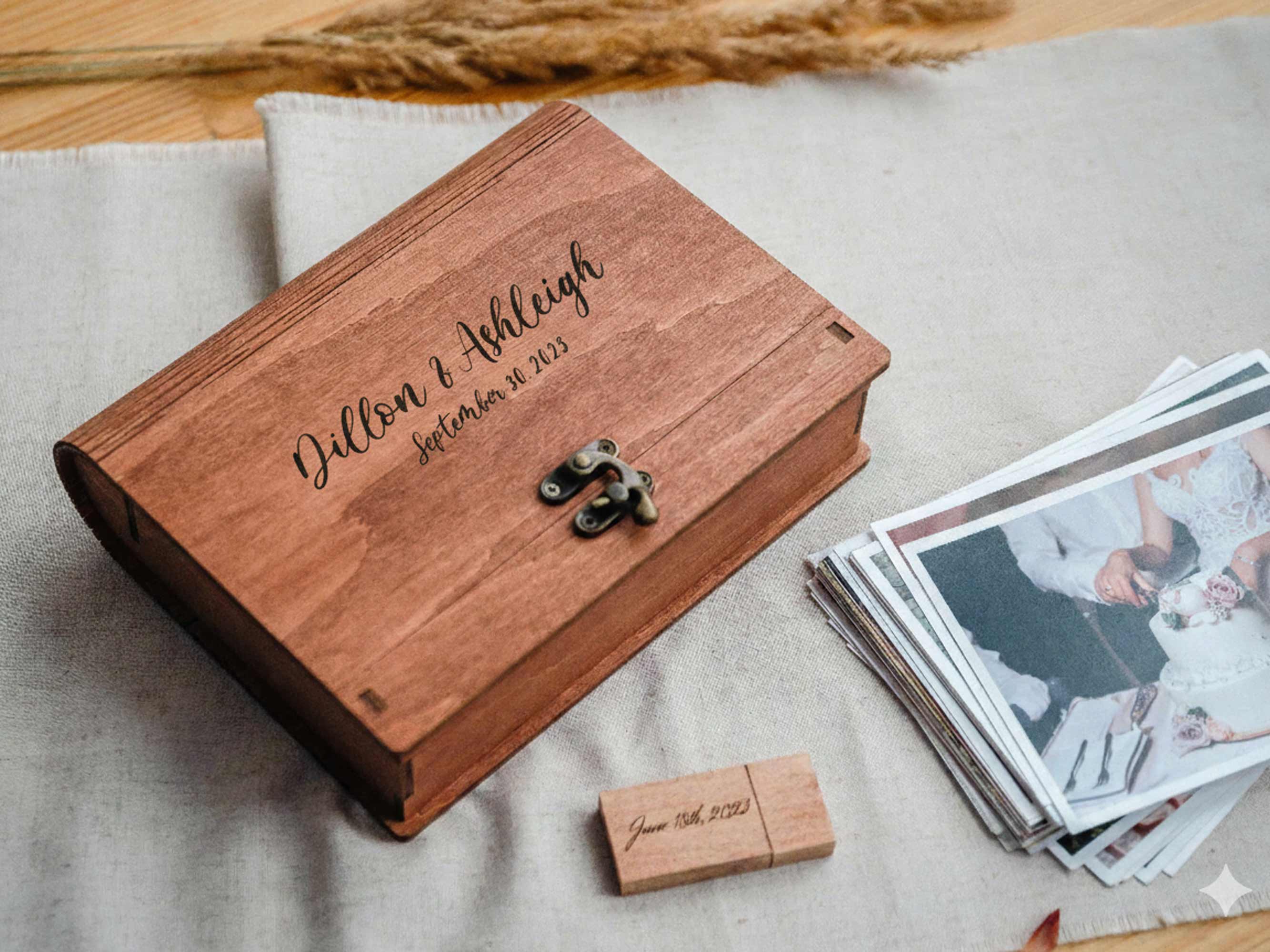 Closed teak wooden photo box with engraved lid, wooden USB and wedding prints nearby