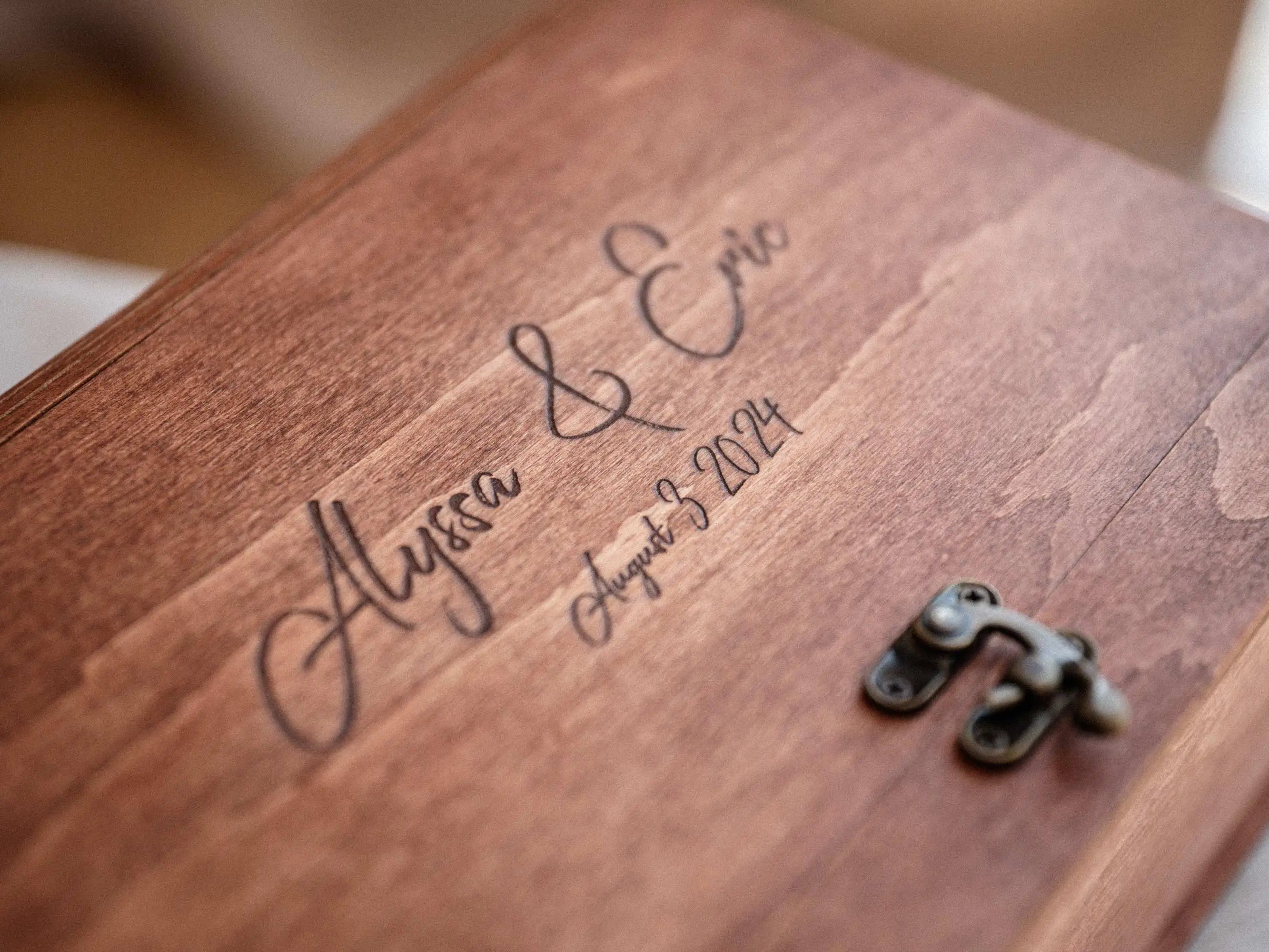 Close-up of engraved teak photo keepsake box lid with names and wedding date