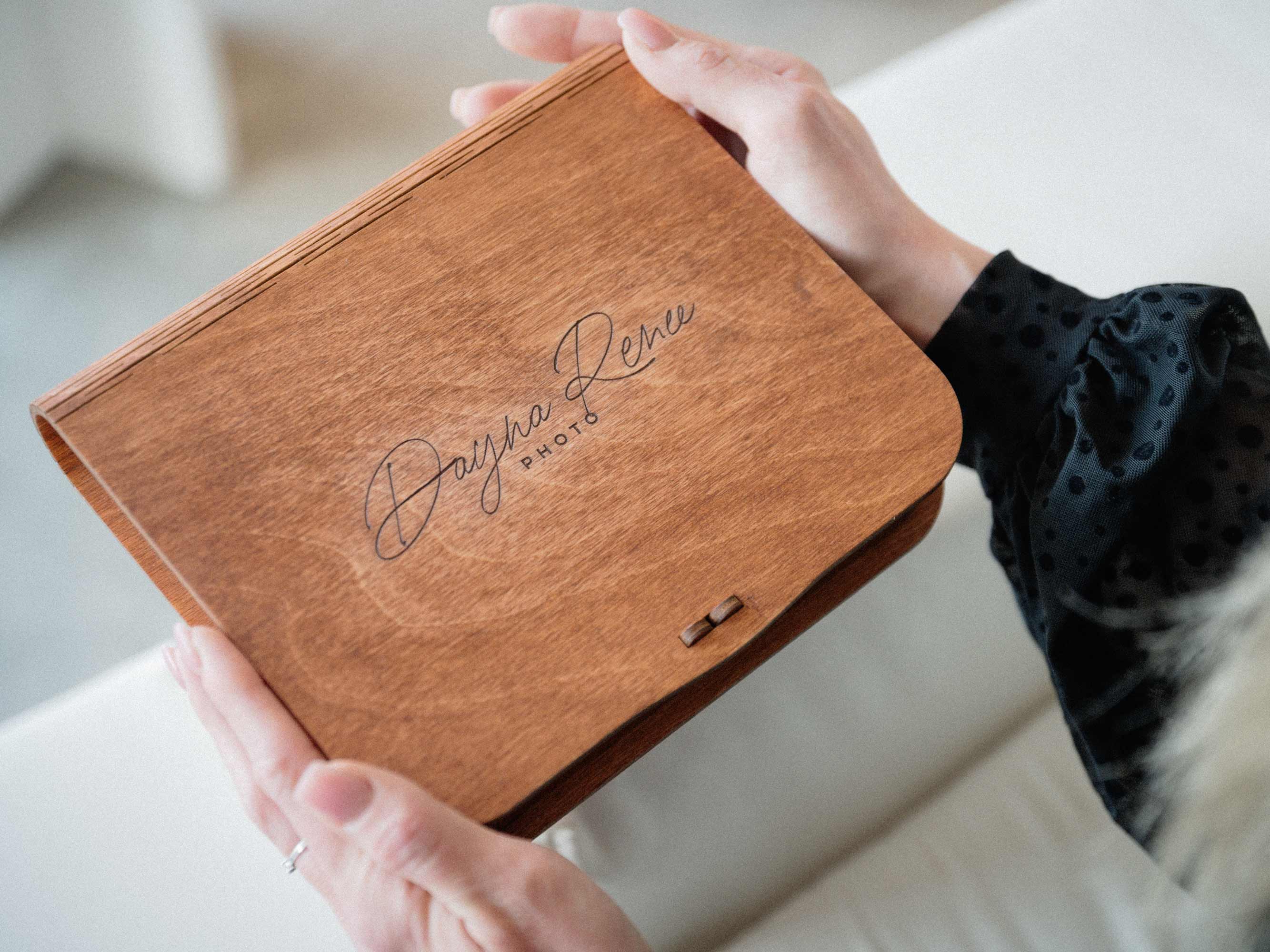 Personalized teak wooden keepsake box for photos held in hands
