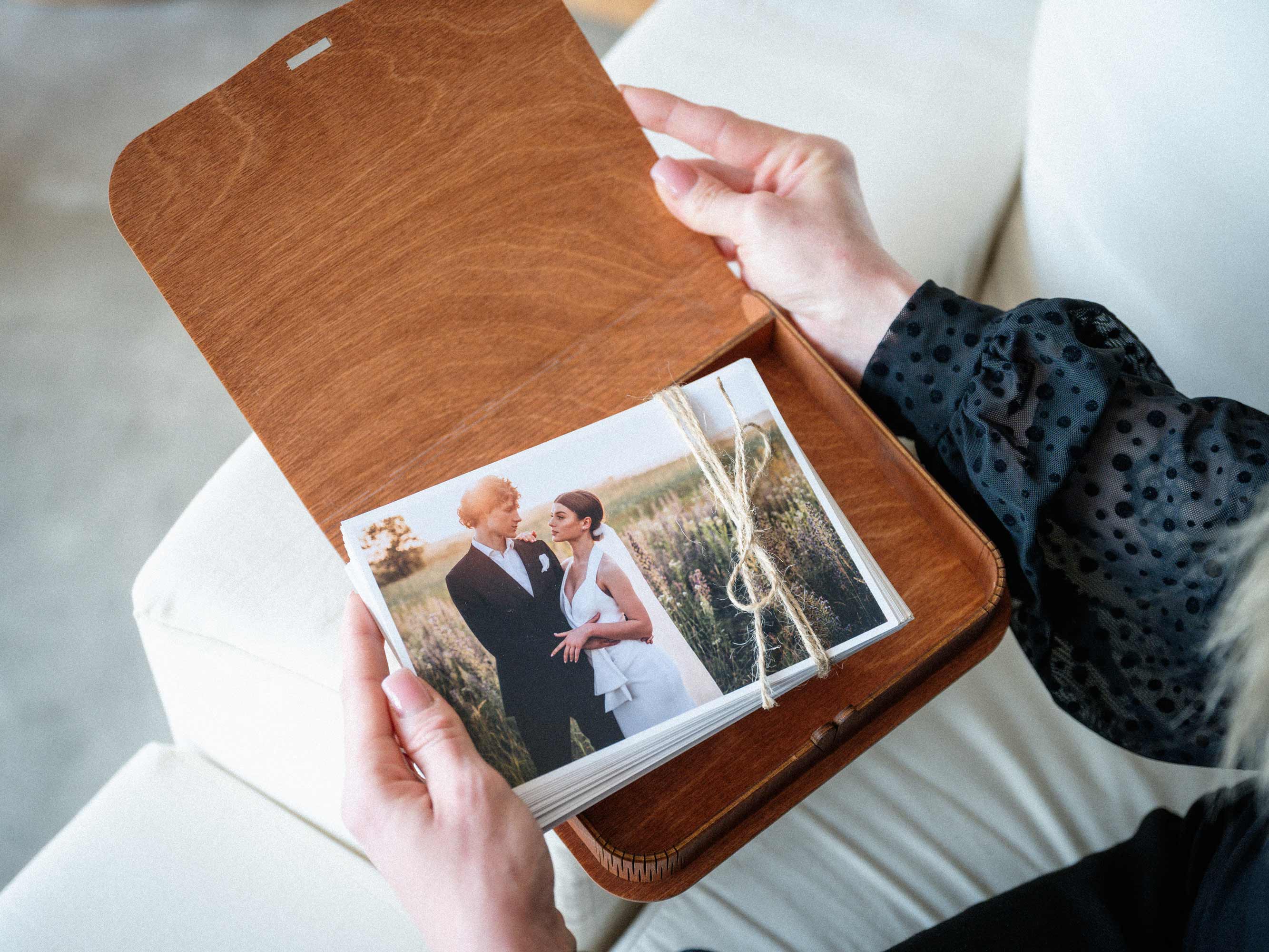 Teak wooden photo keepsake box open with printed photos inside