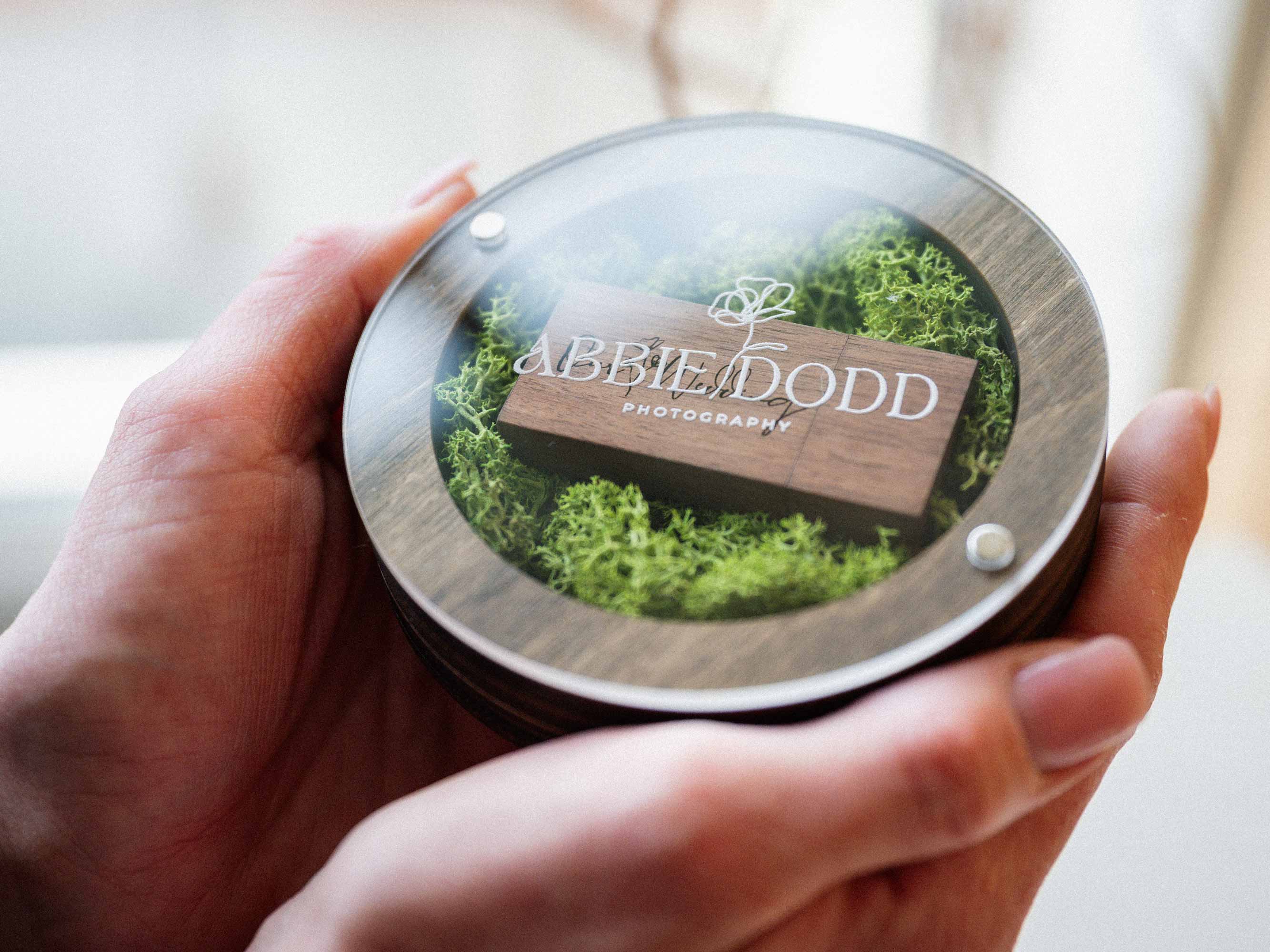 Walnut USB box with acrylic lid shown in hands for size and presentation