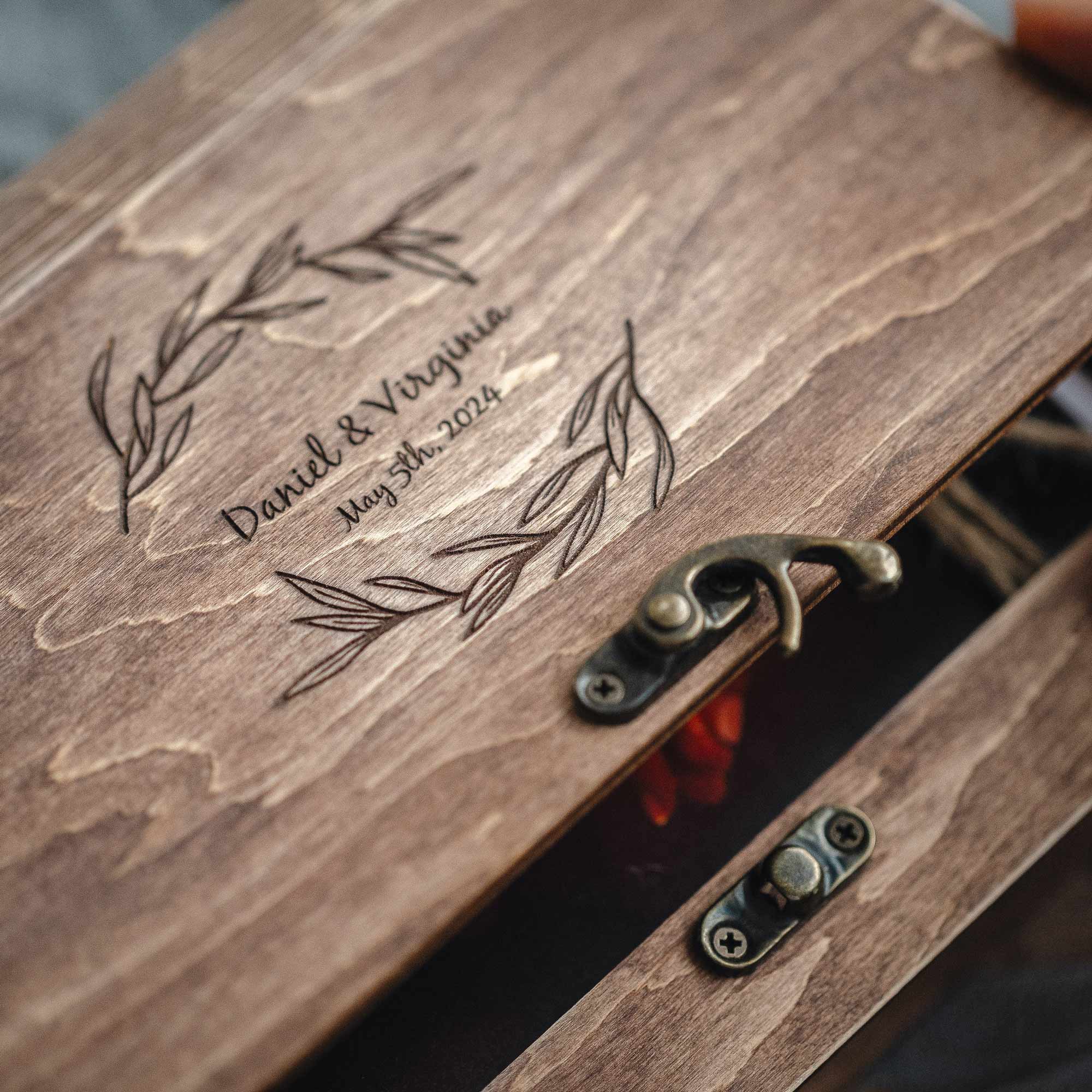 Close-up of engraved lid and vintage metal hook lock with photos peeking from walnut photo box