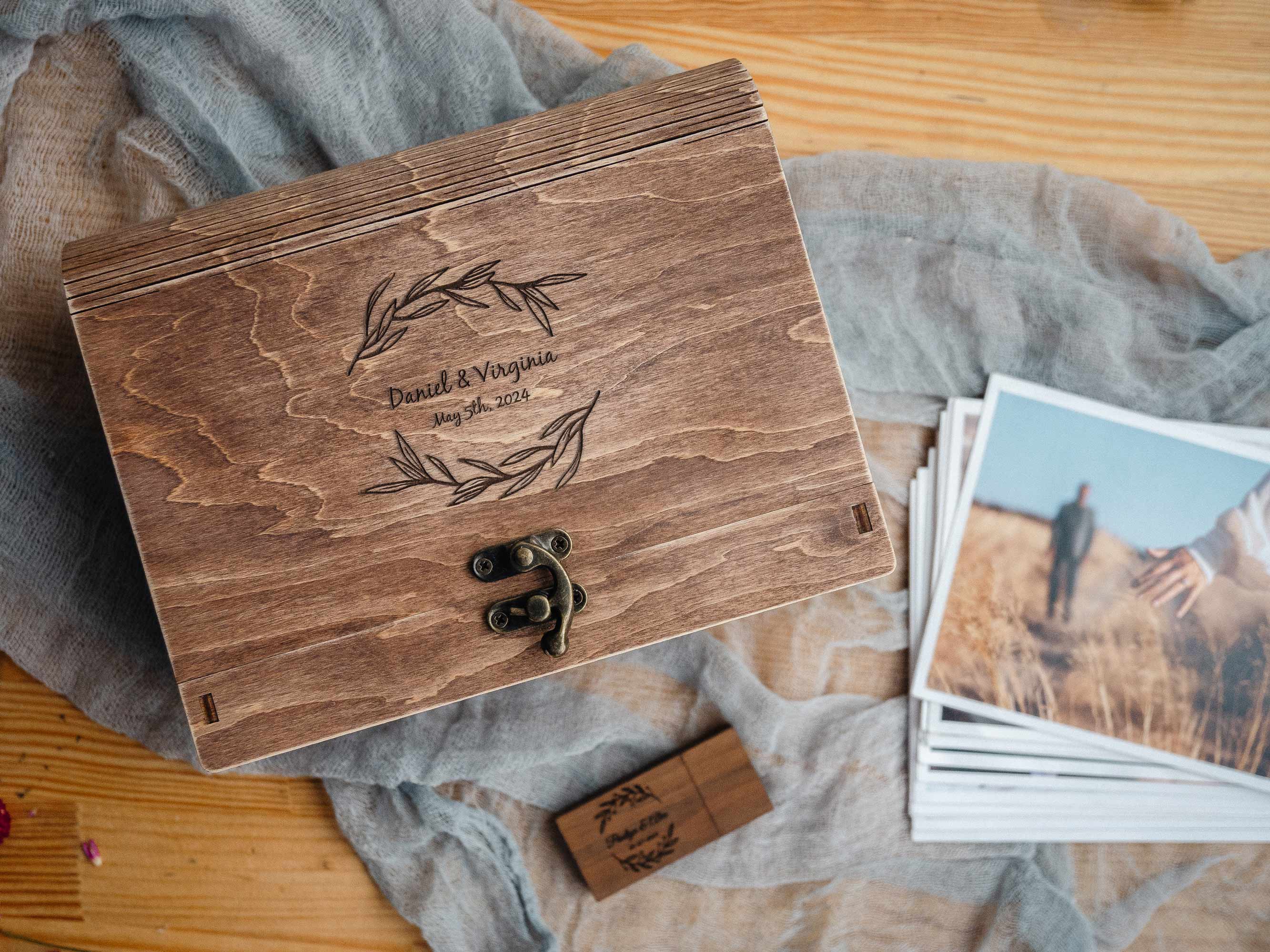 Personalized walnut photo box with prints and wooden USB, flat lay photography packaging setup