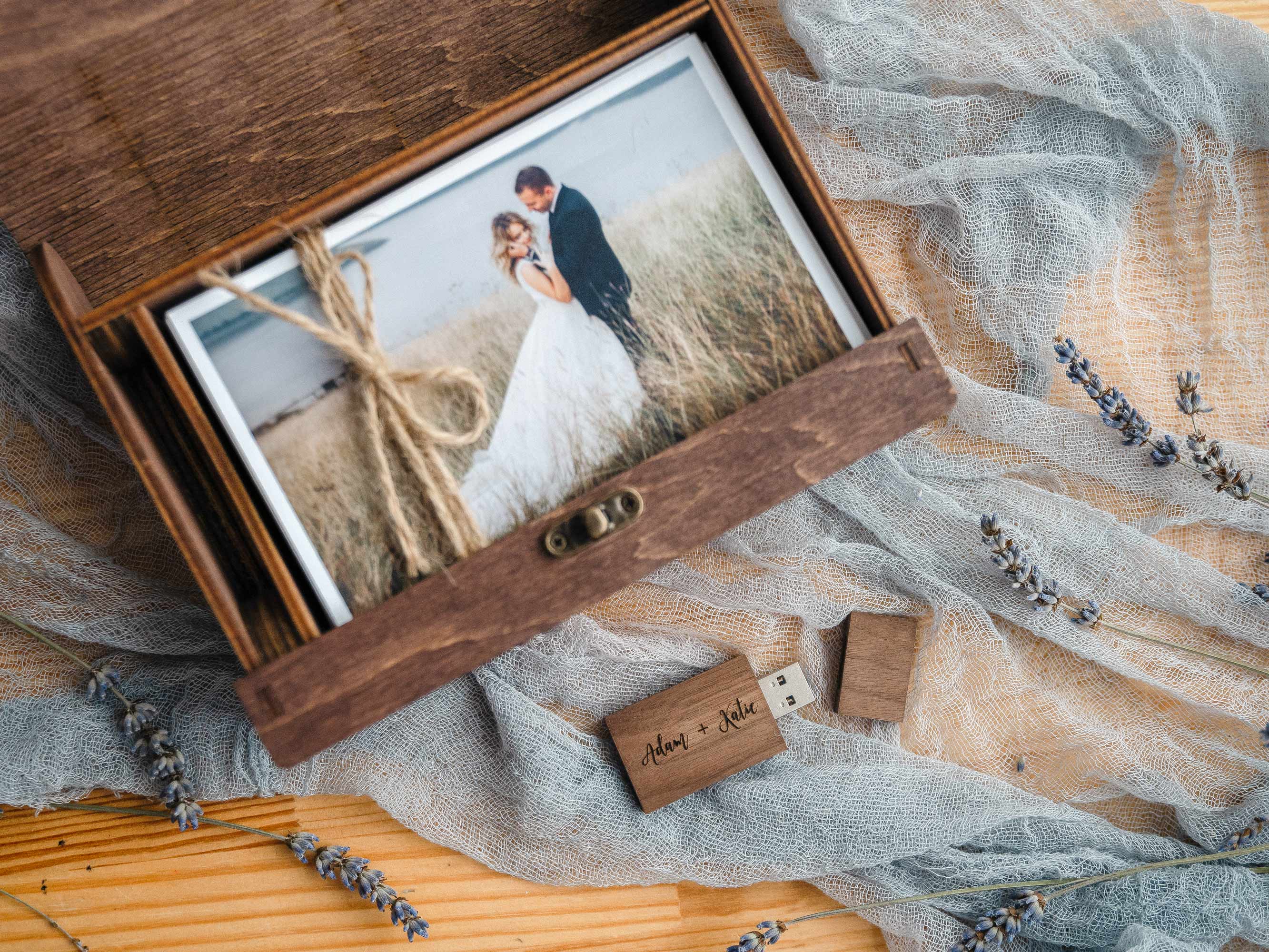 Open walnut photo box displaying wedding prints, designed for premium client presentation