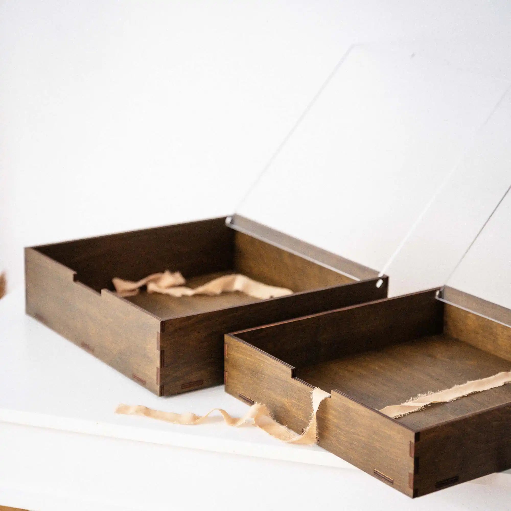 Open walnut photo album storage boxes with acrylic lids in different depths