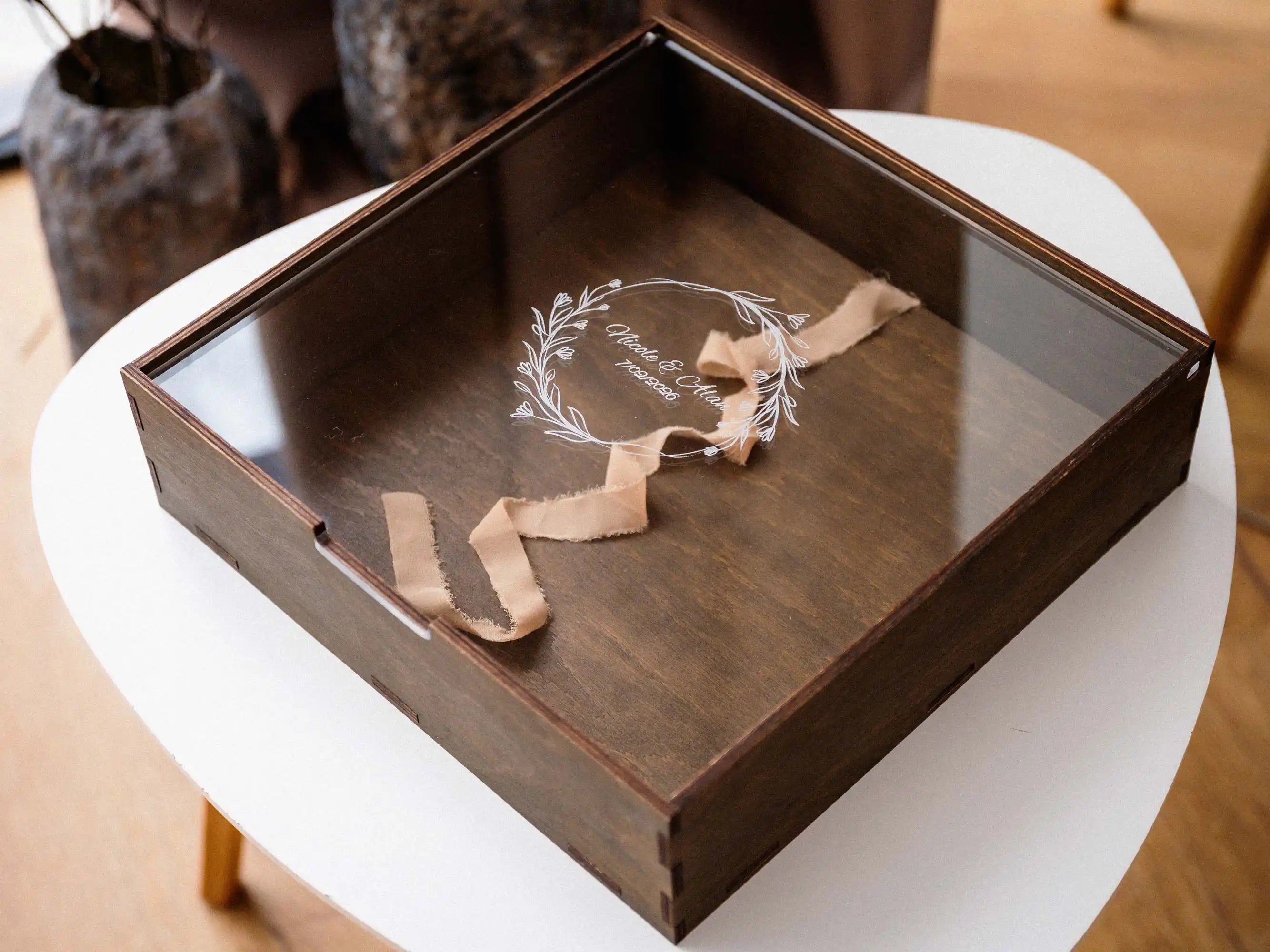 Empty walnut photo album box with acrylic lid and ribbon pull