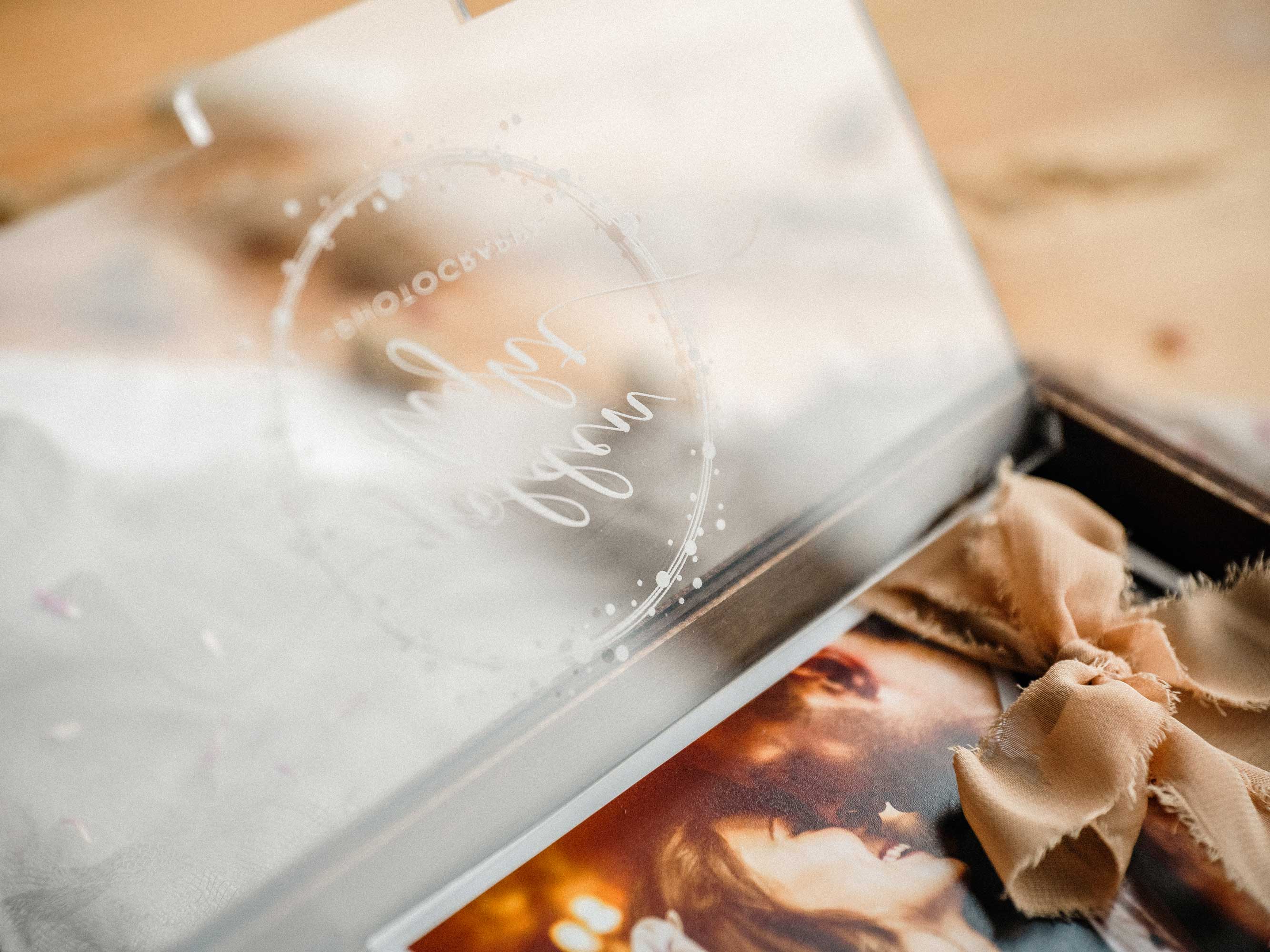 Handcrafted wooden wedding photo box with USB compartment and printed photo in hands