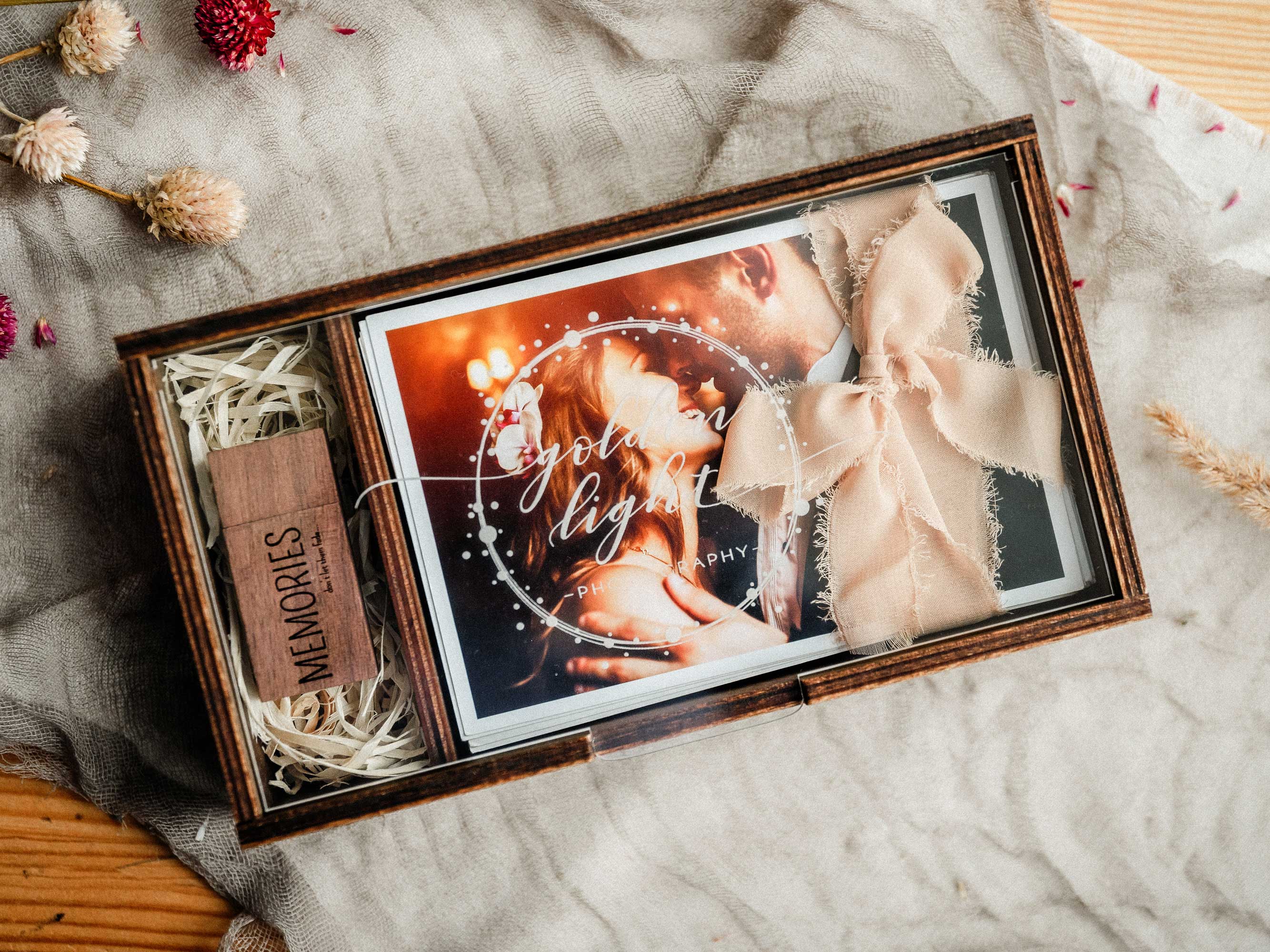 Top view of an open wooden photo box with USB compartment and wedding photo print