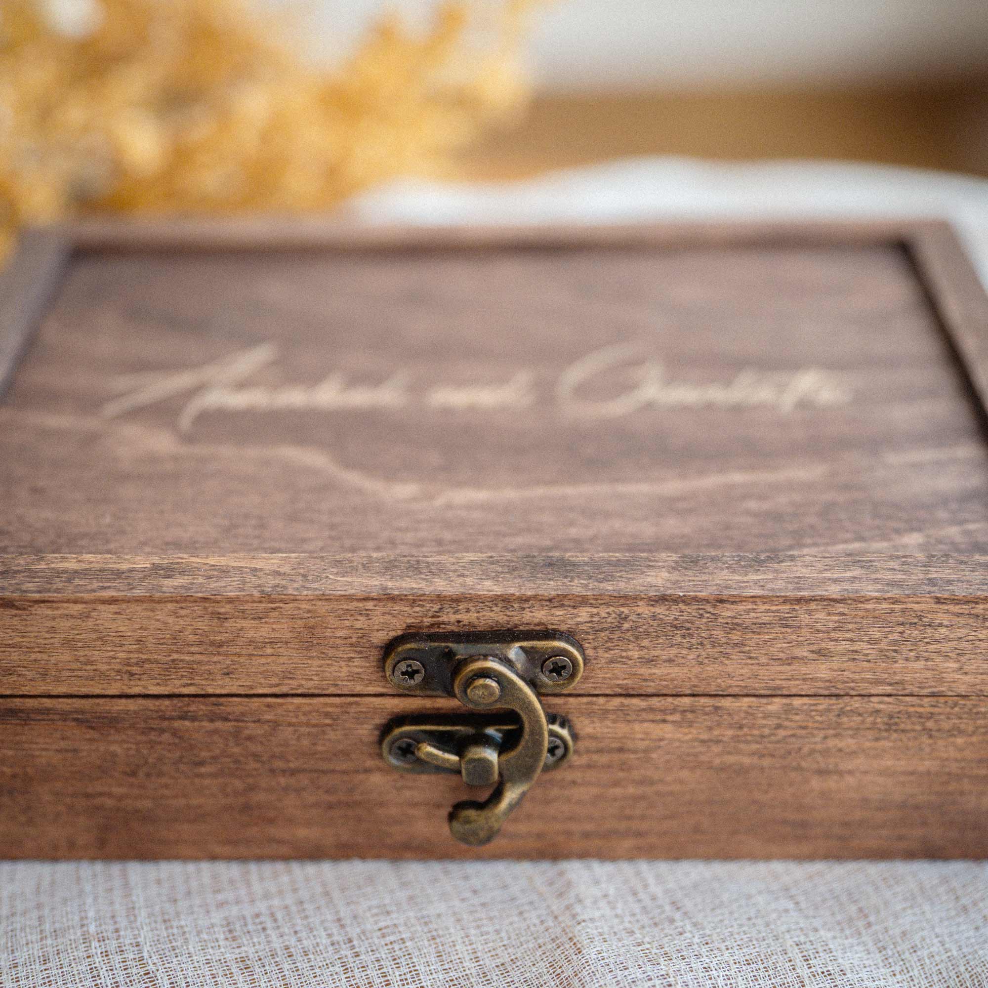 Close-up of Walnut Classic photo box with metal closure and engraved lid