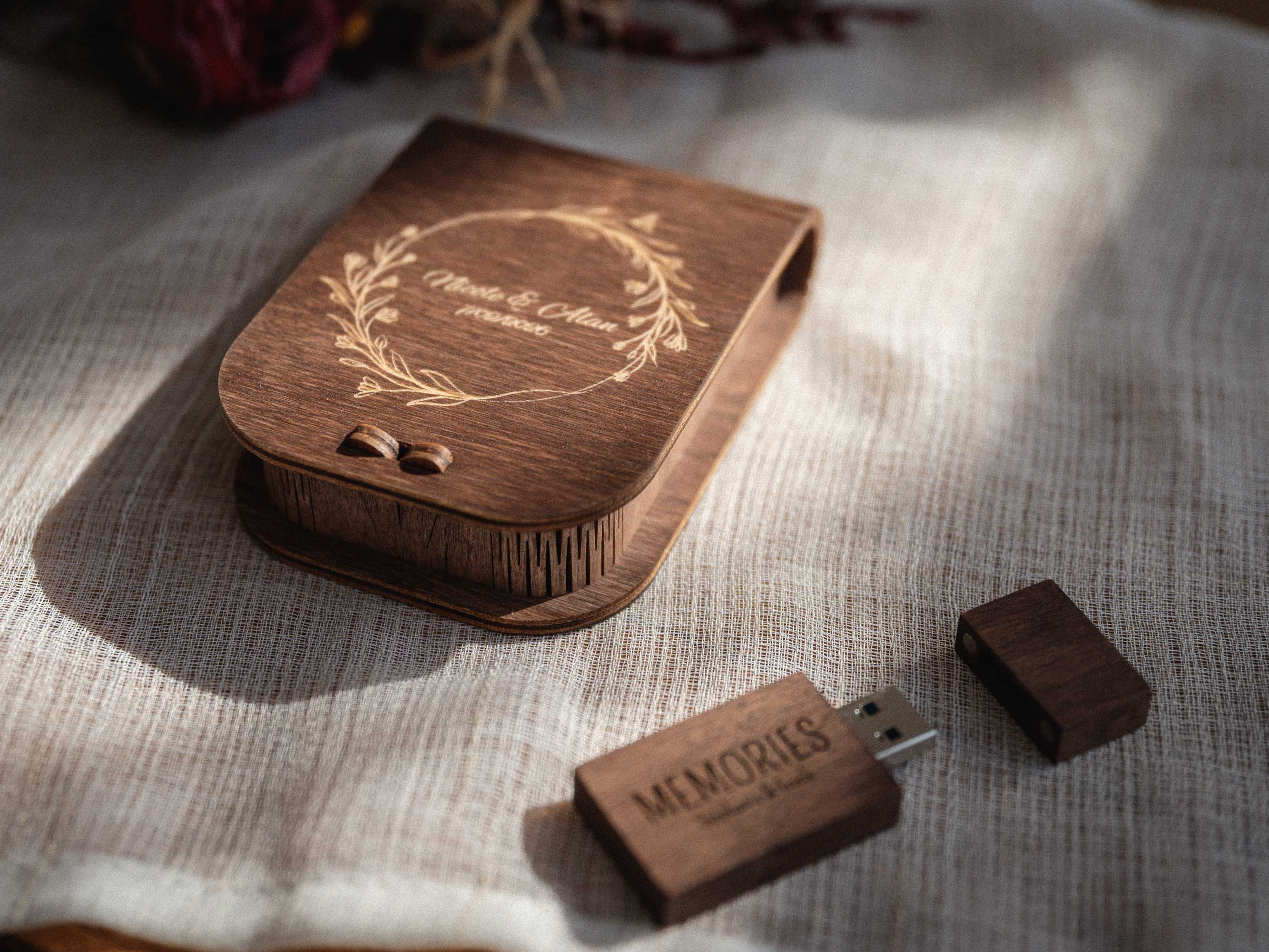 Walnut wedding USB box with personalized wooden flash drive on linen background