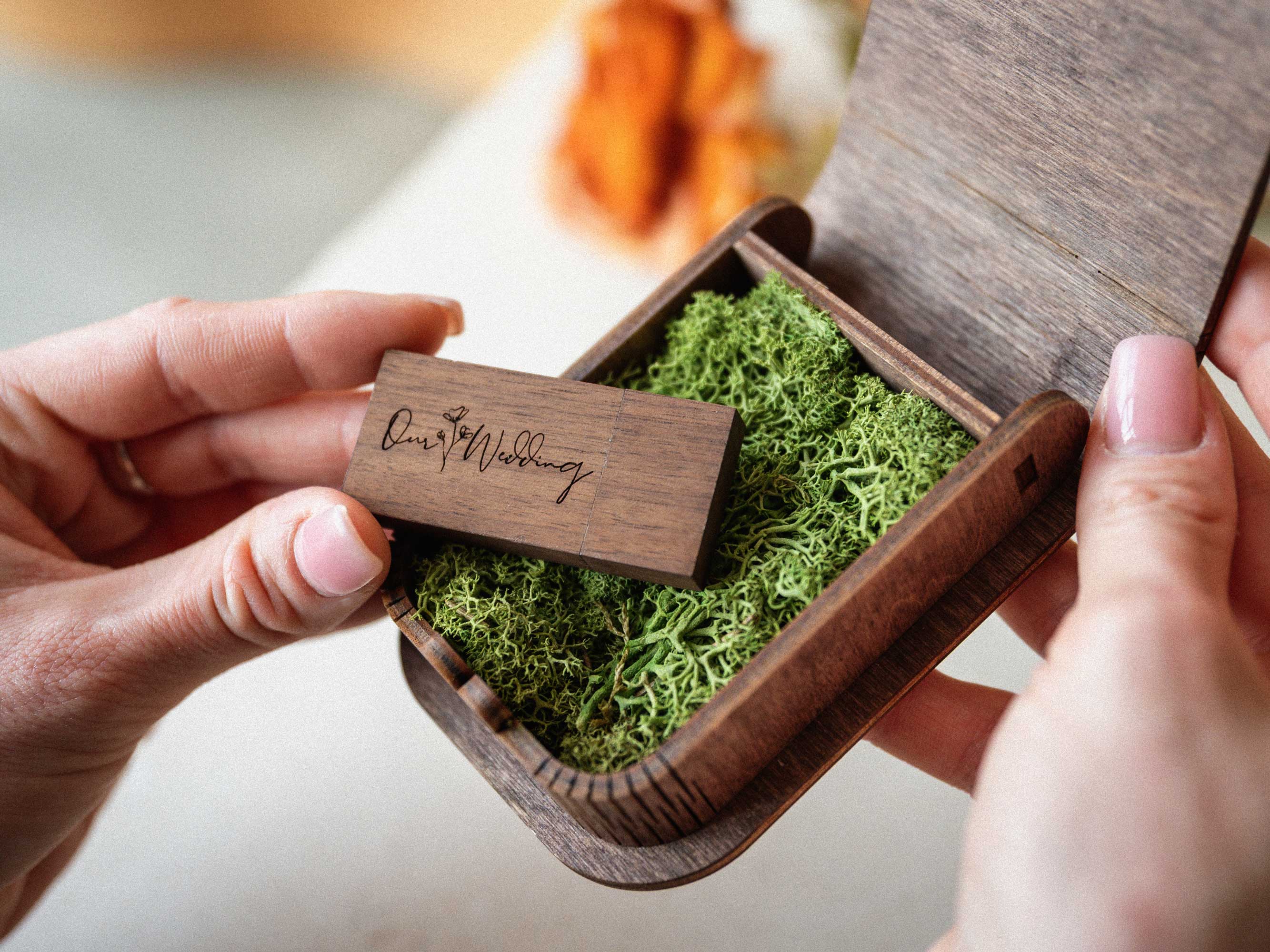 Personalized walnut USB box with wooden flash drive being removed by hand