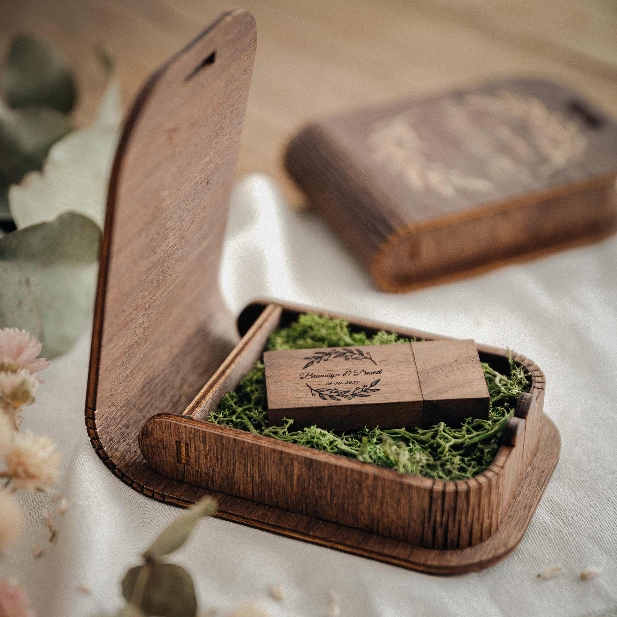 Open walnut wedding USB box with engraved wooden flash drive and moss filler