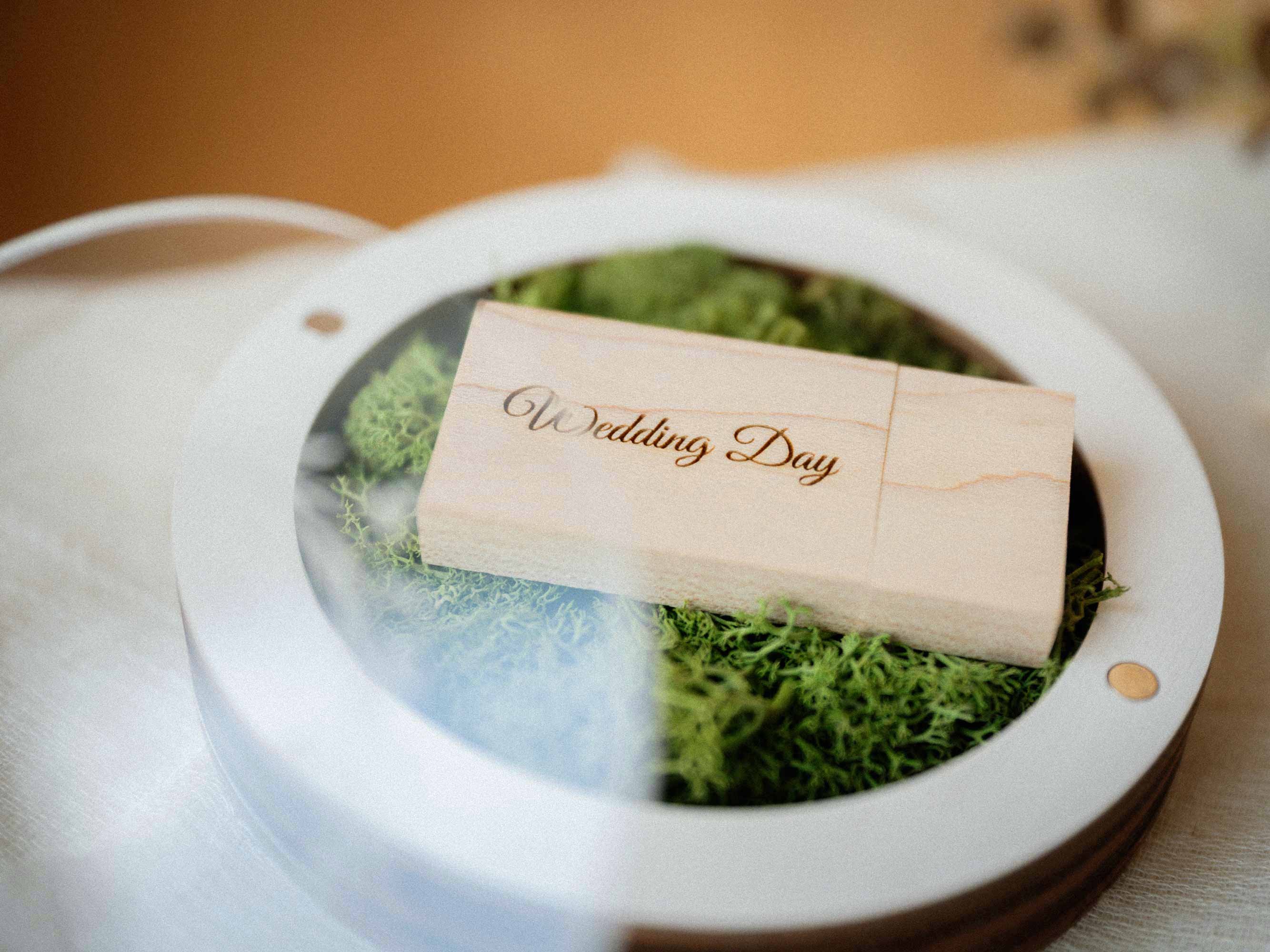 White wedding USB box with acrylic lid and light wooden flash drive close up