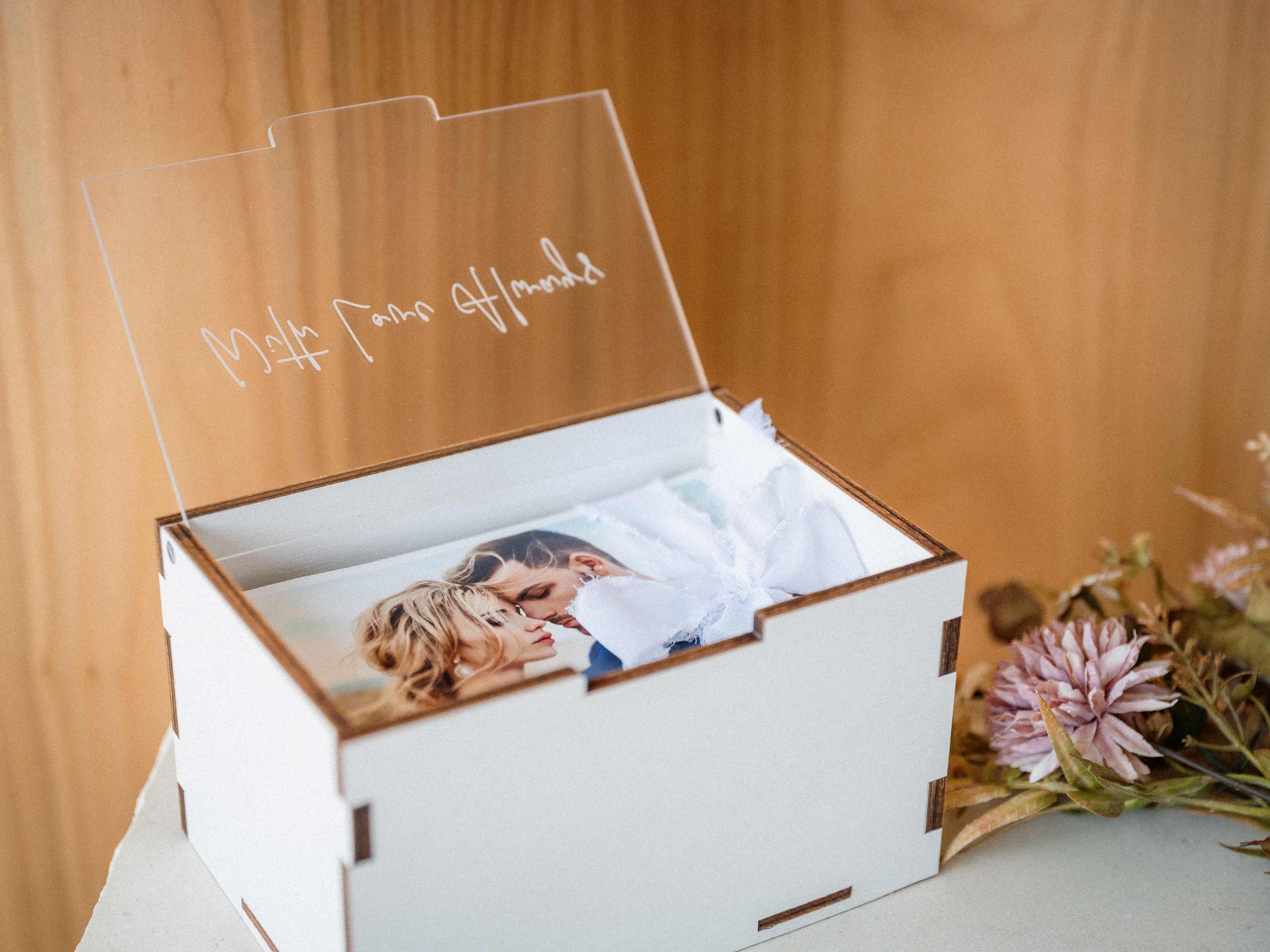 White wooden photo box with engraved acrylic lid and 4x6 wedding prints
