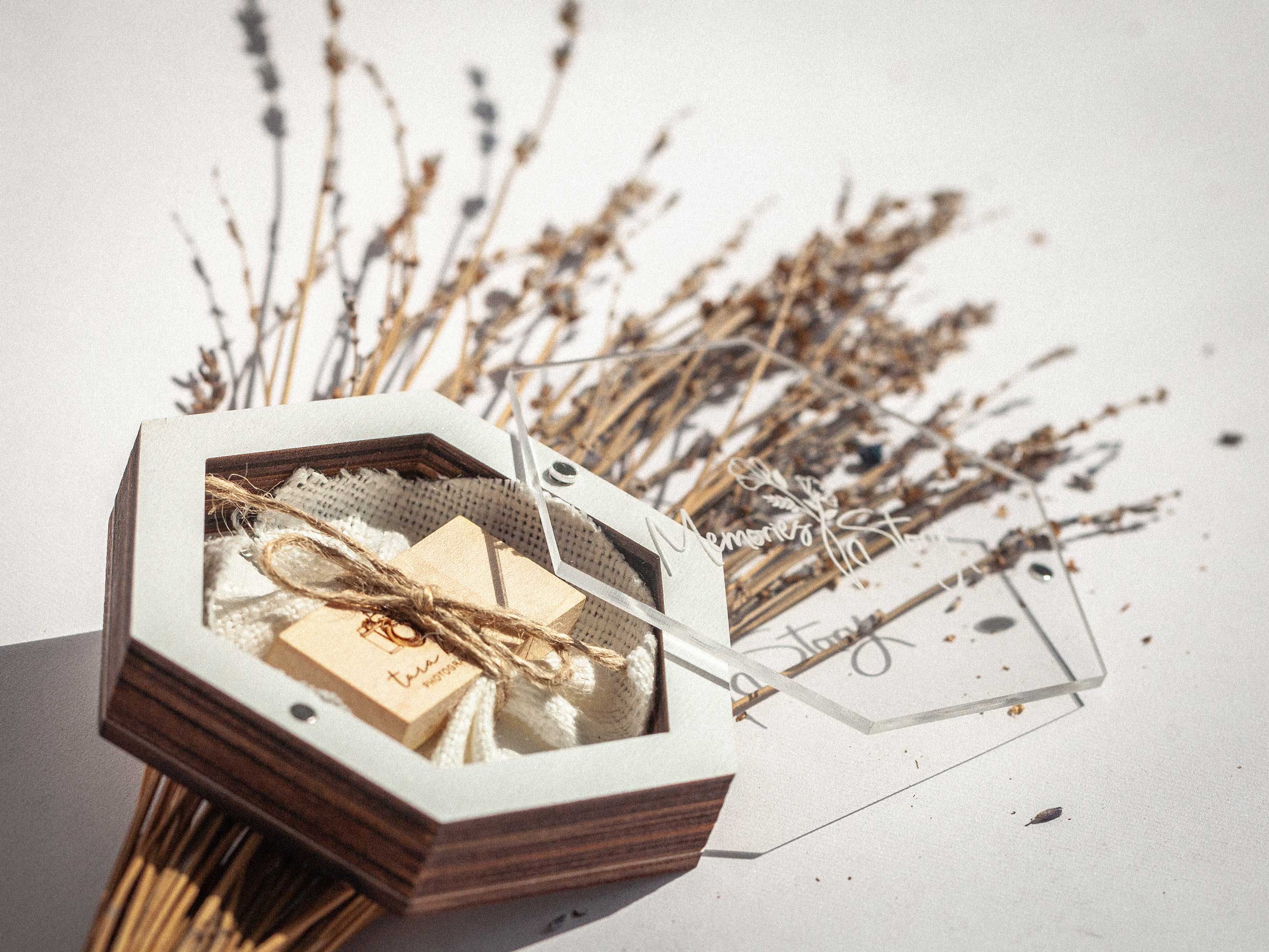 Open white hexagon USB box with wooden flash drive and acrylic lid aside