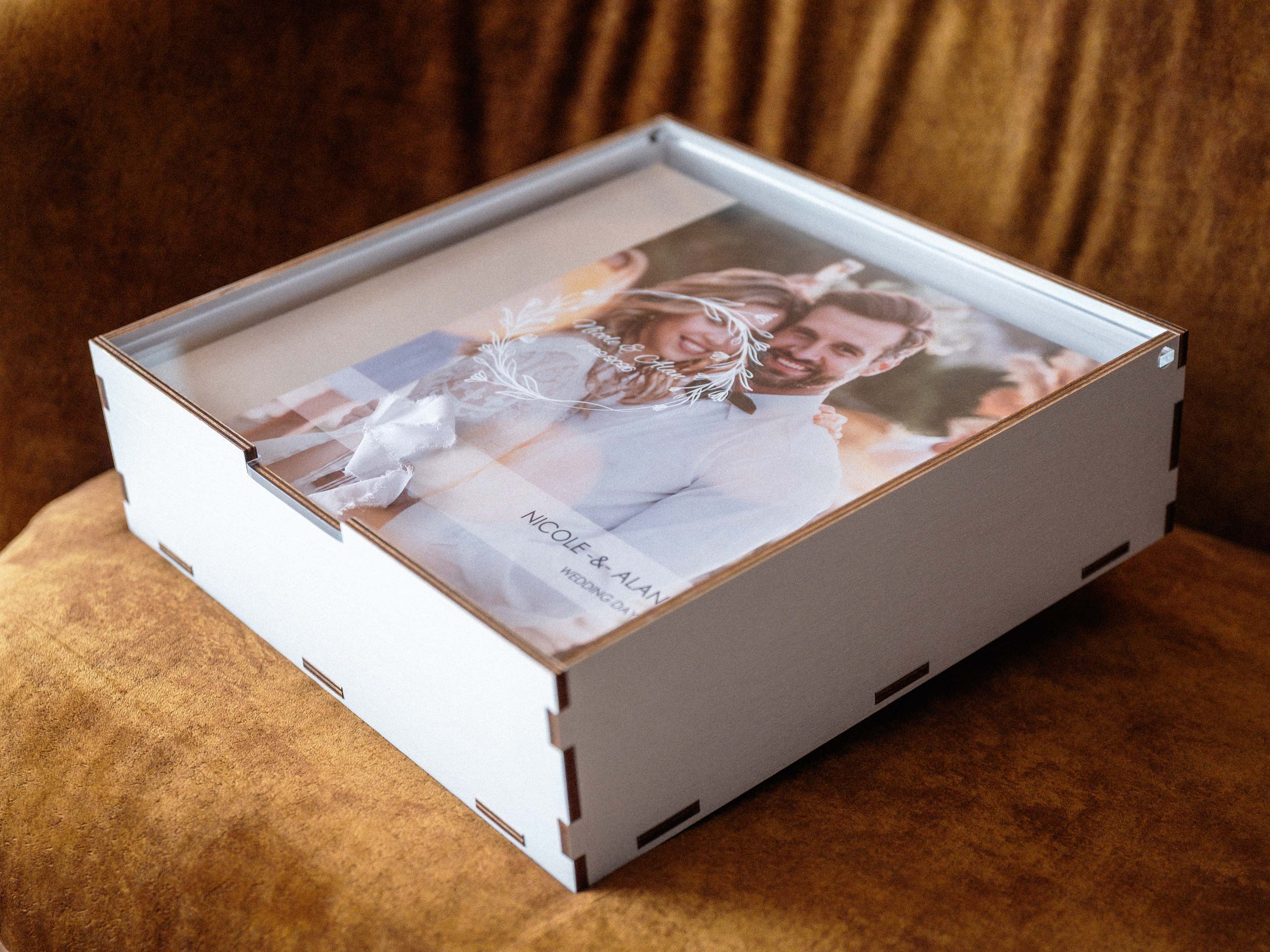 White personalized album box with acrylic lid closed, elegant photo album packaging