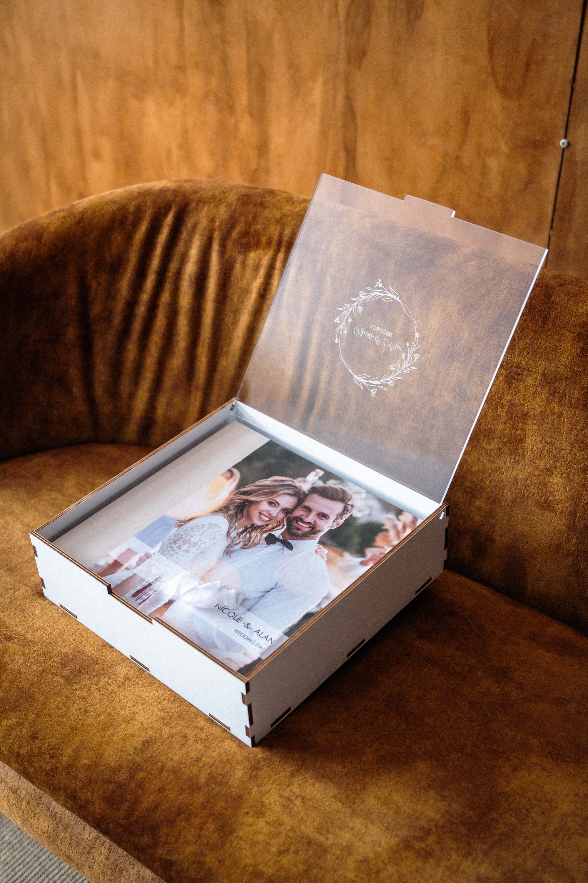 Open white wooden box with personalized acrylic lid for 10x10 wedding photo album
