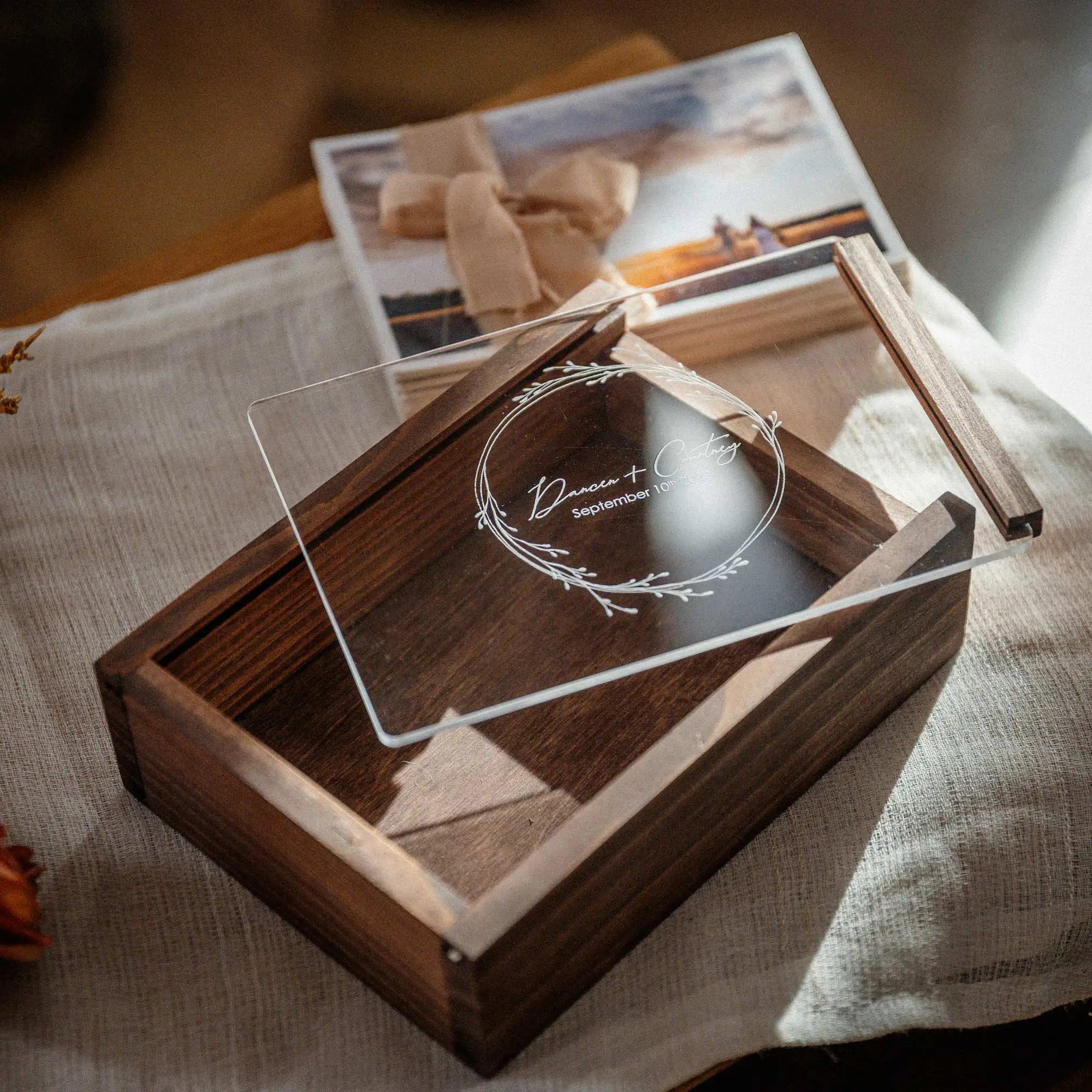 Walnut wooden photo box with removed acrylic lid and print bundle on top