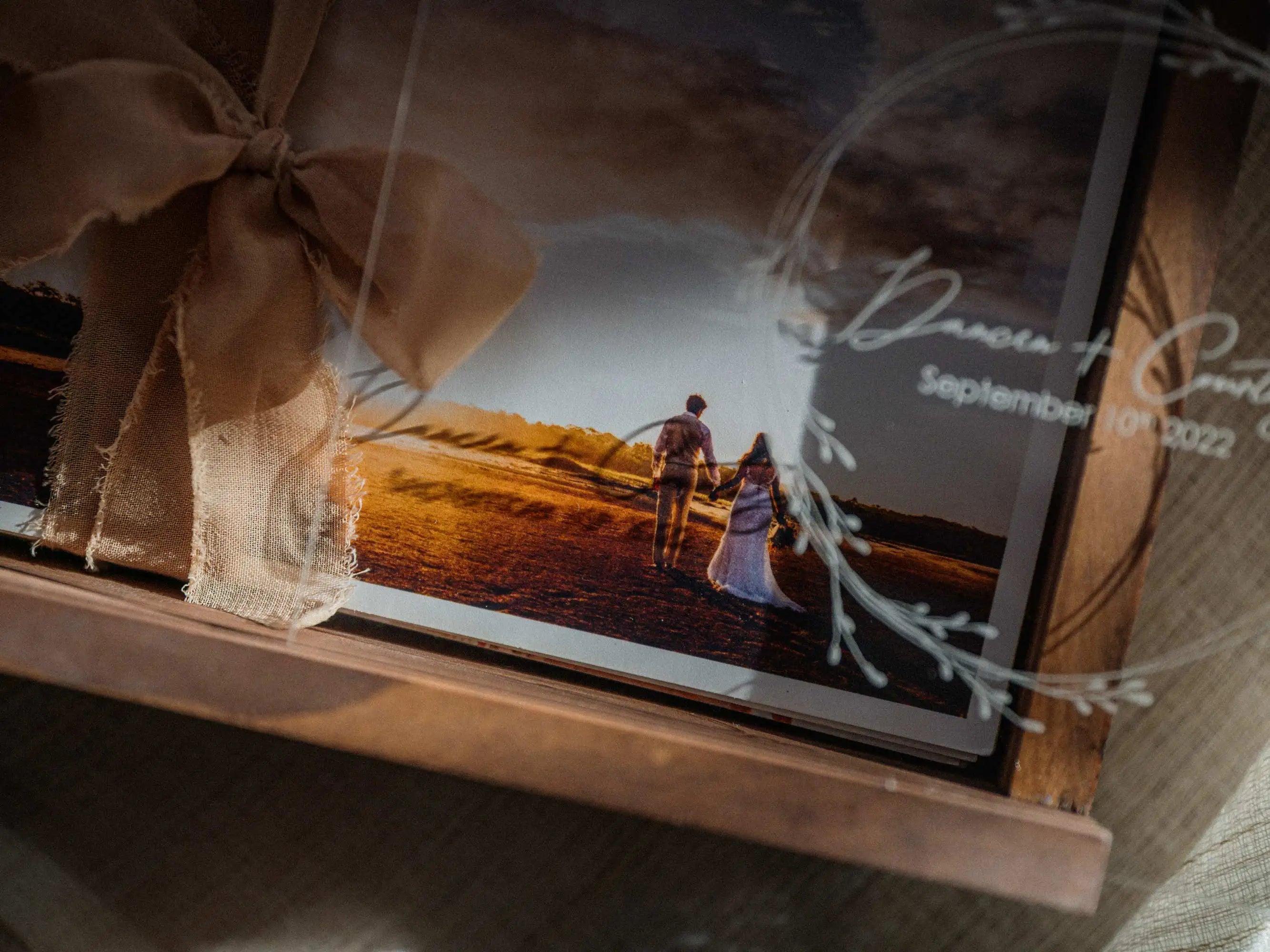 Close-up of personalized walnut photo box with acrylic lid and wedding print